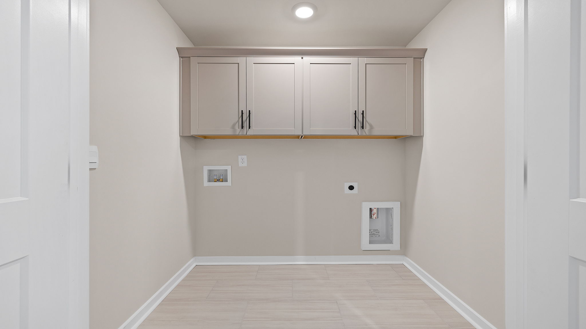 Laundry room with cabinets.
