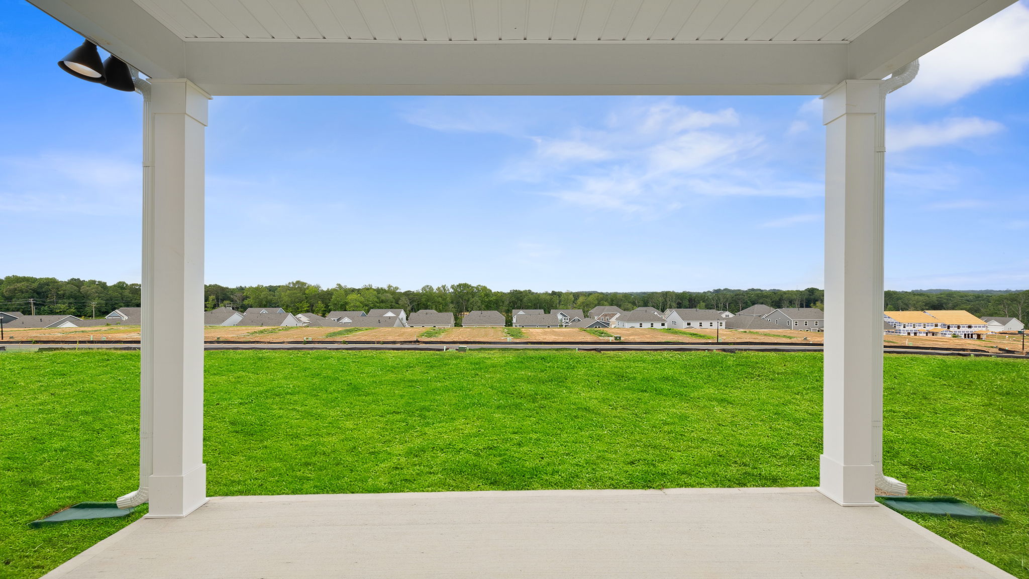 Back exterior with covered patio.