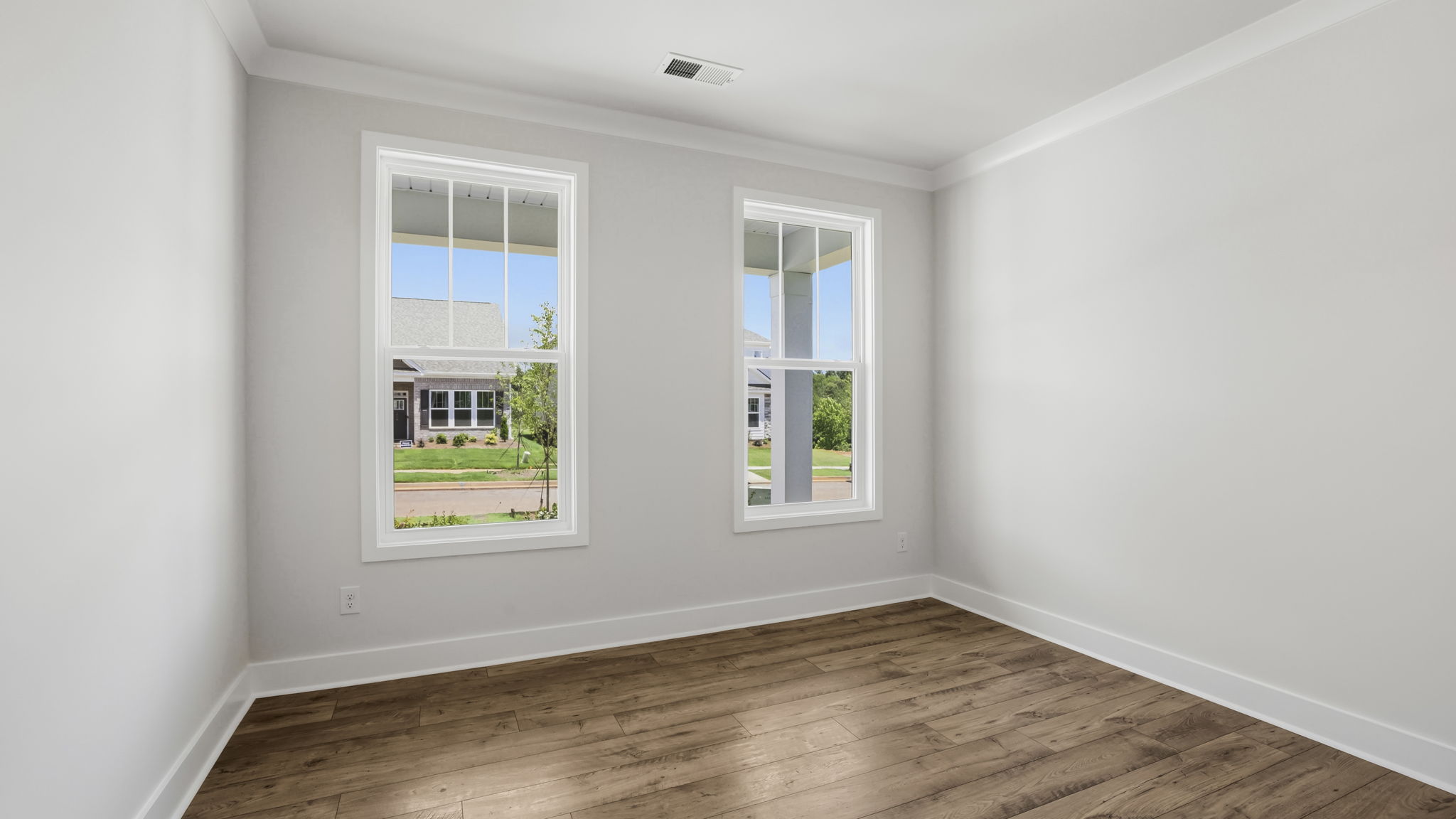 Bedroom with carpet and windows.