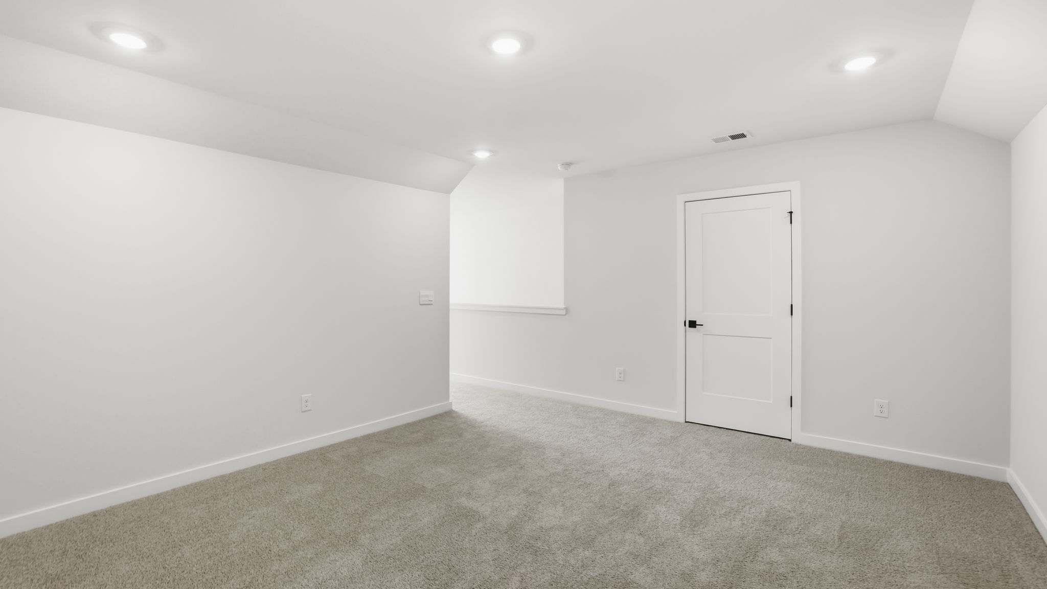 Bonus room with carpet and windows.