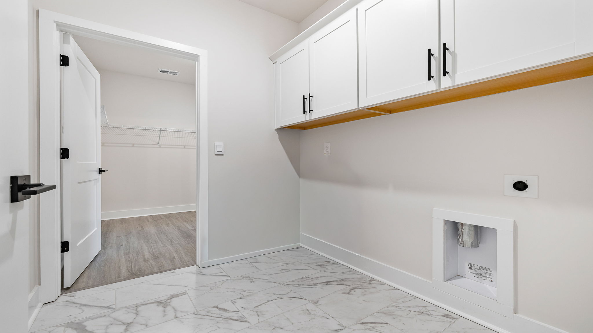 Laundry room with cabinets.