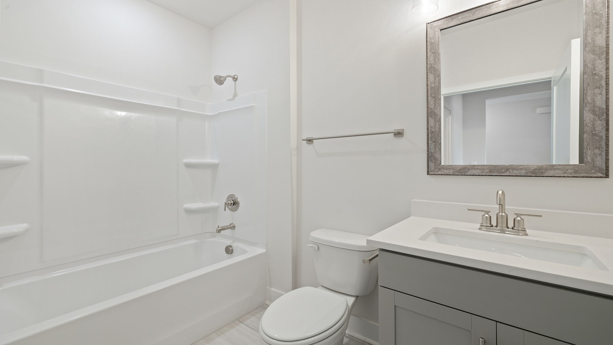 Hall bathroom with vanity and combination shower / tub.