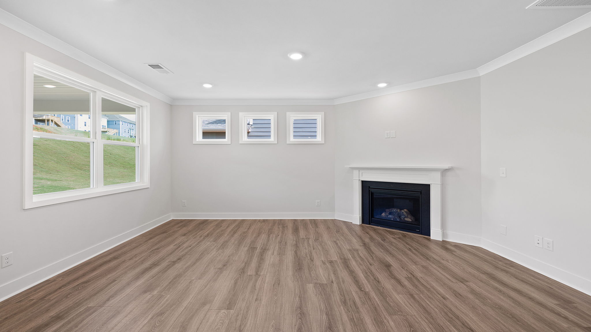 Family room with lots of windows and gas log fireplace.