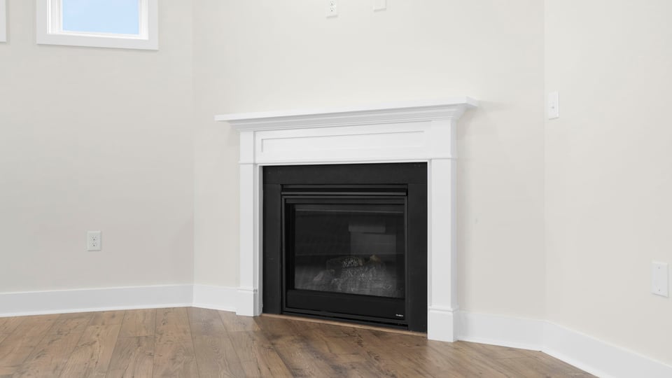 Living room with window and fireplace.