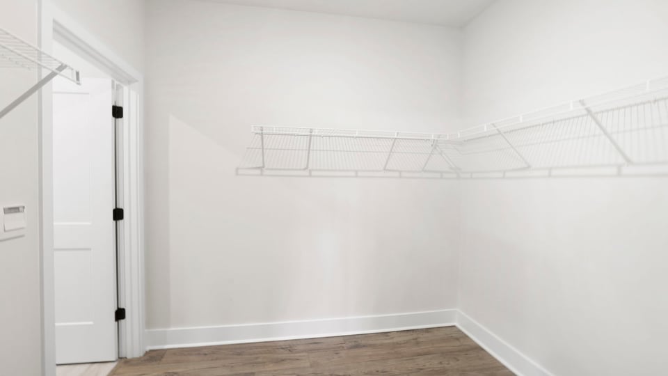Primary closet with shelf.