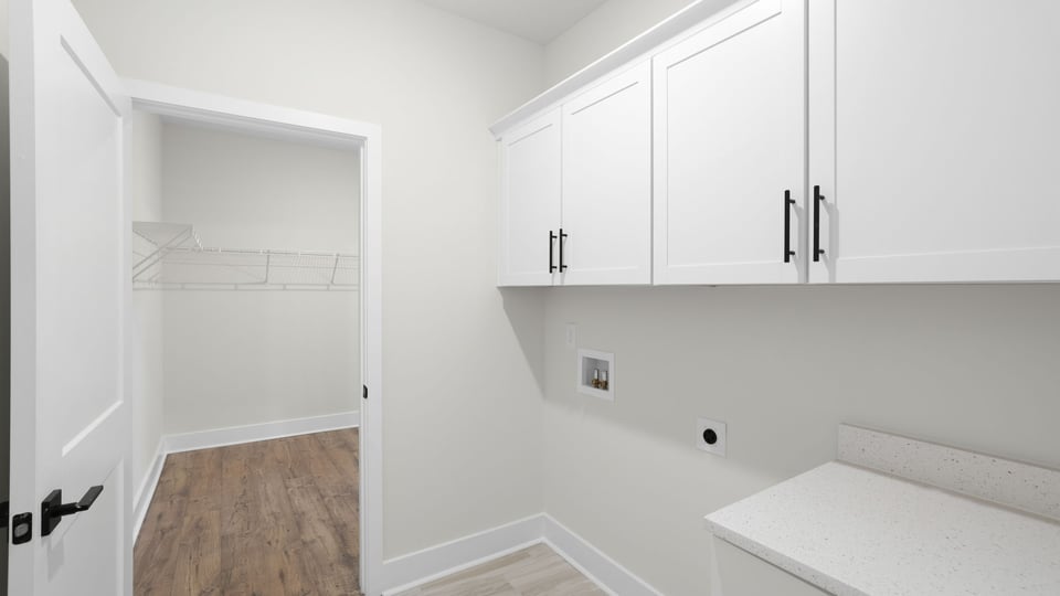Laundry room with shelf.