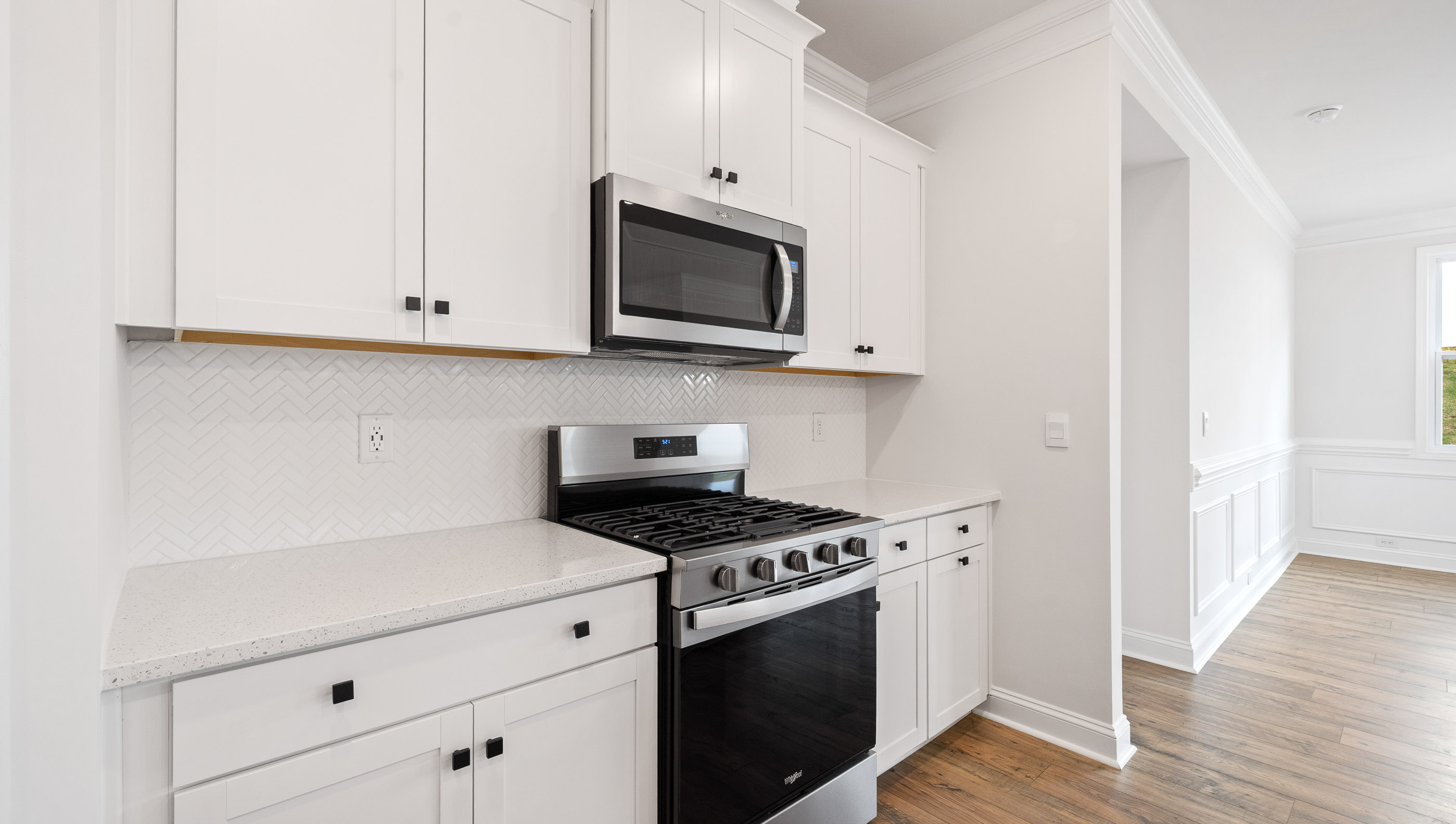 Kitchen and island with stainless steel appliances.