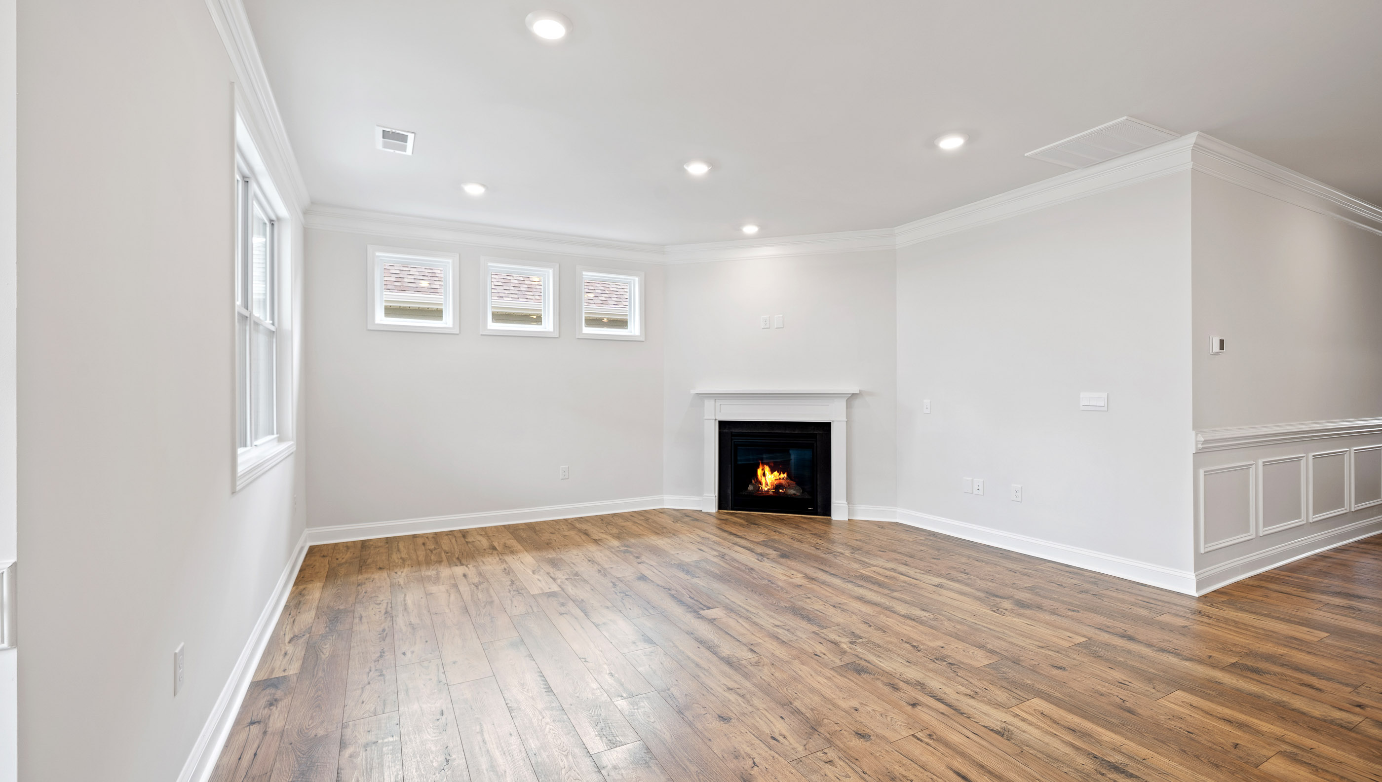 Living room with windows and fireplace.