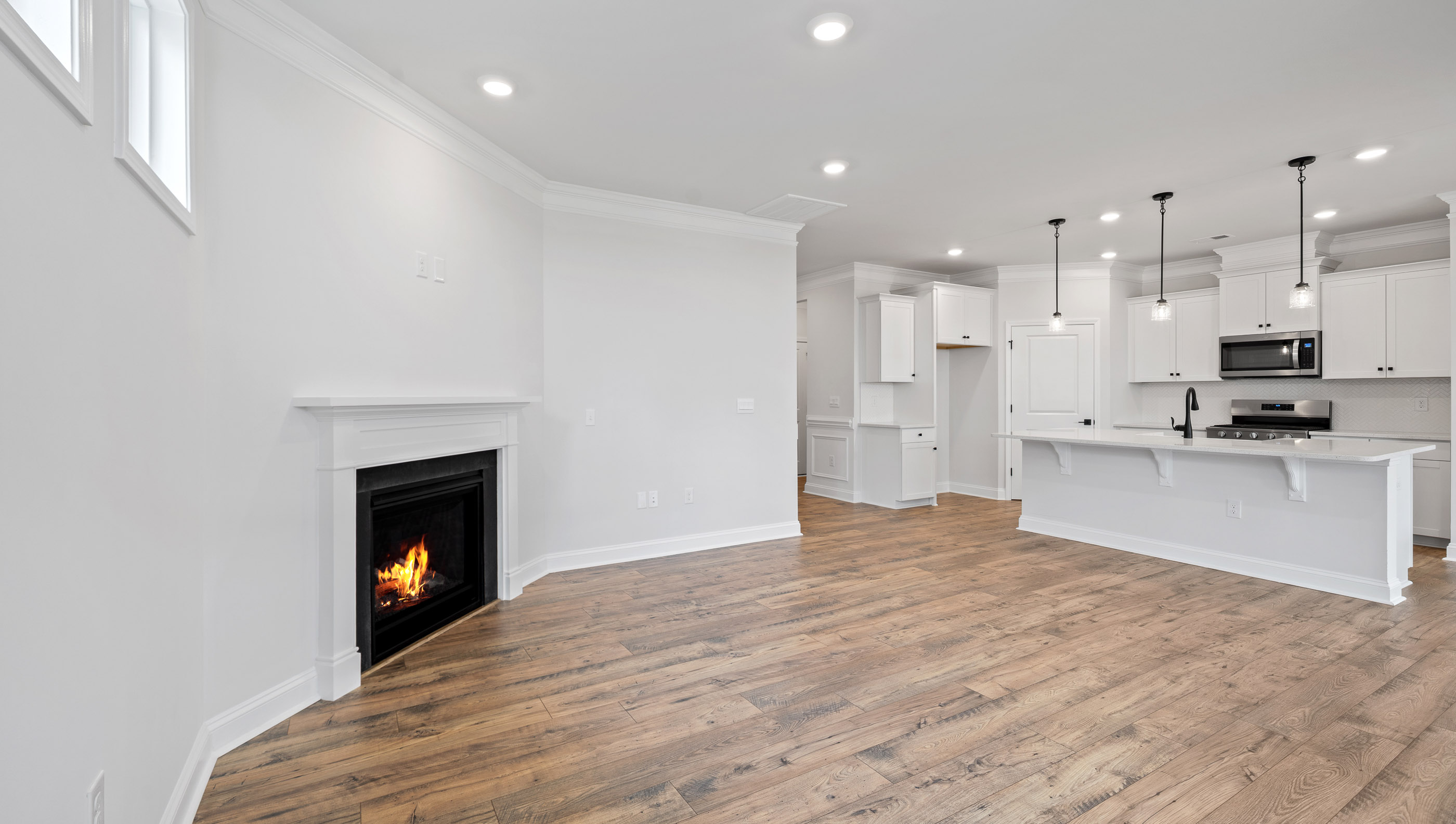 Living room with windows and fireplace.