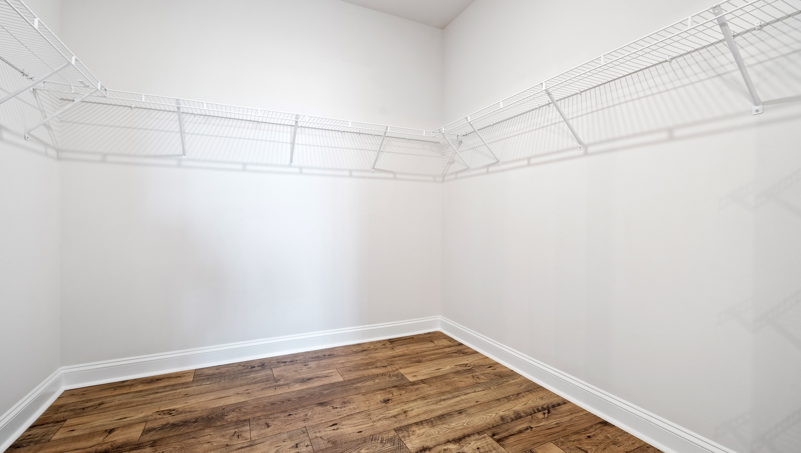 Closet with hanging storage racks.