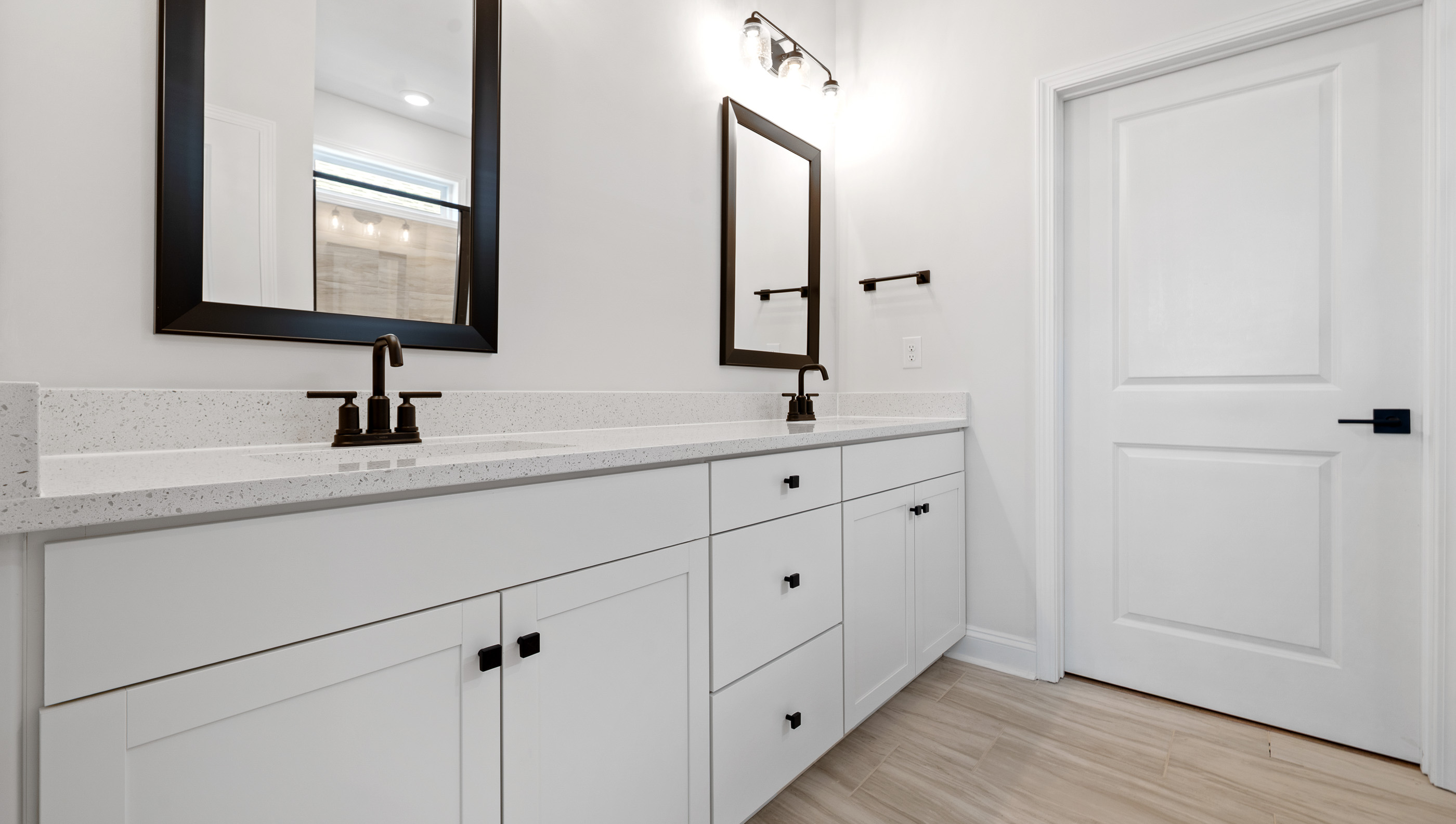 Bathroom with double vanity sink and closet.
