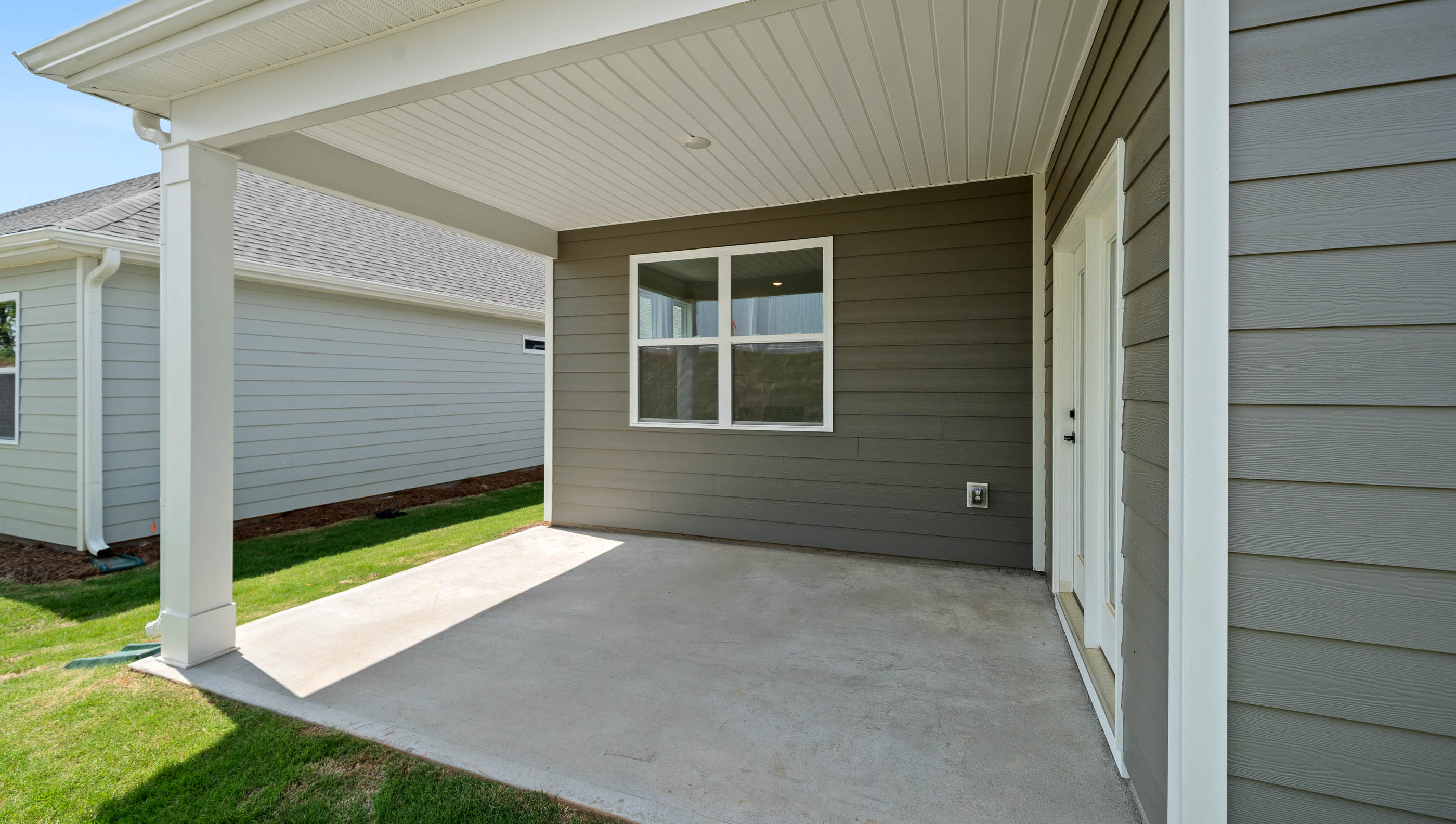 Back exterior of home with covered patio.