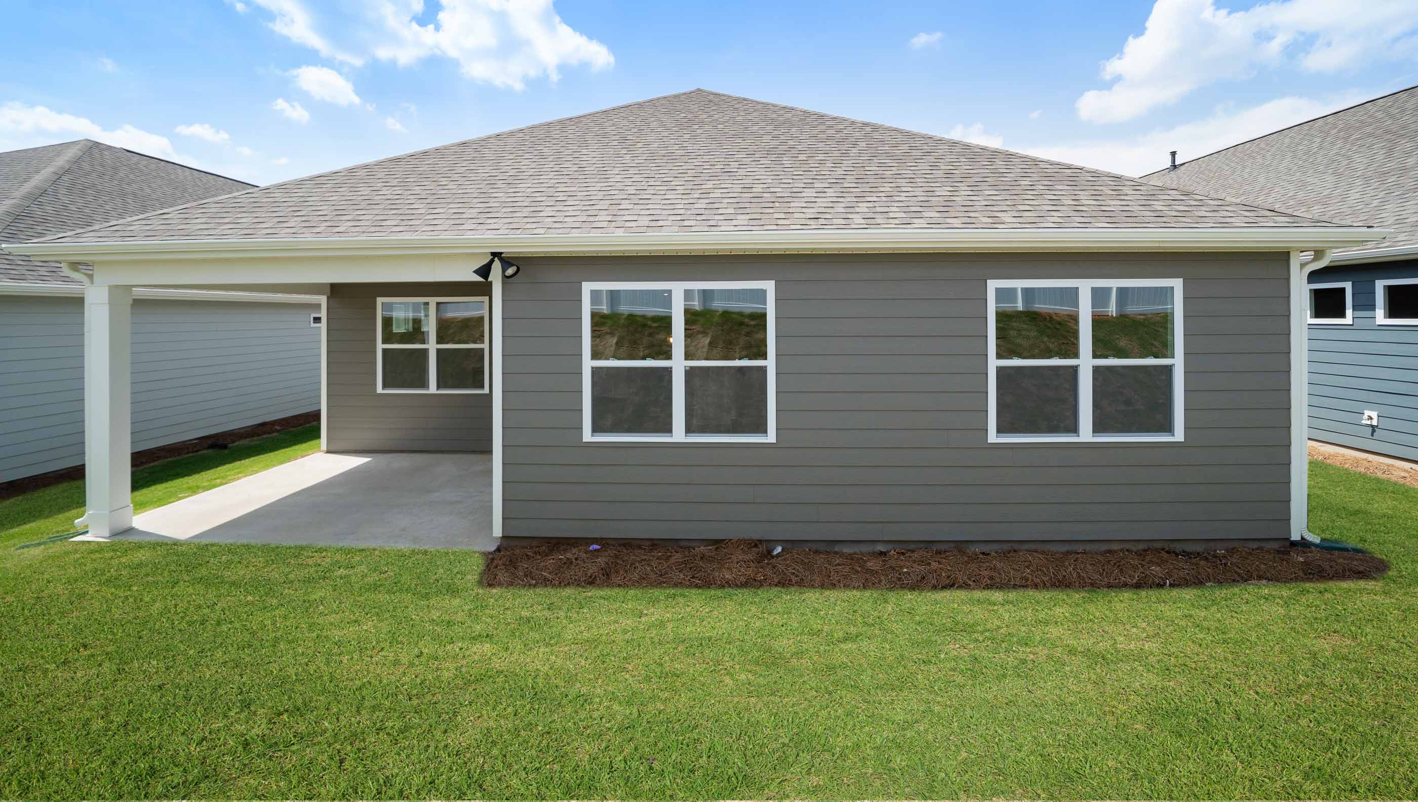 Back exterior of home with large backyard.