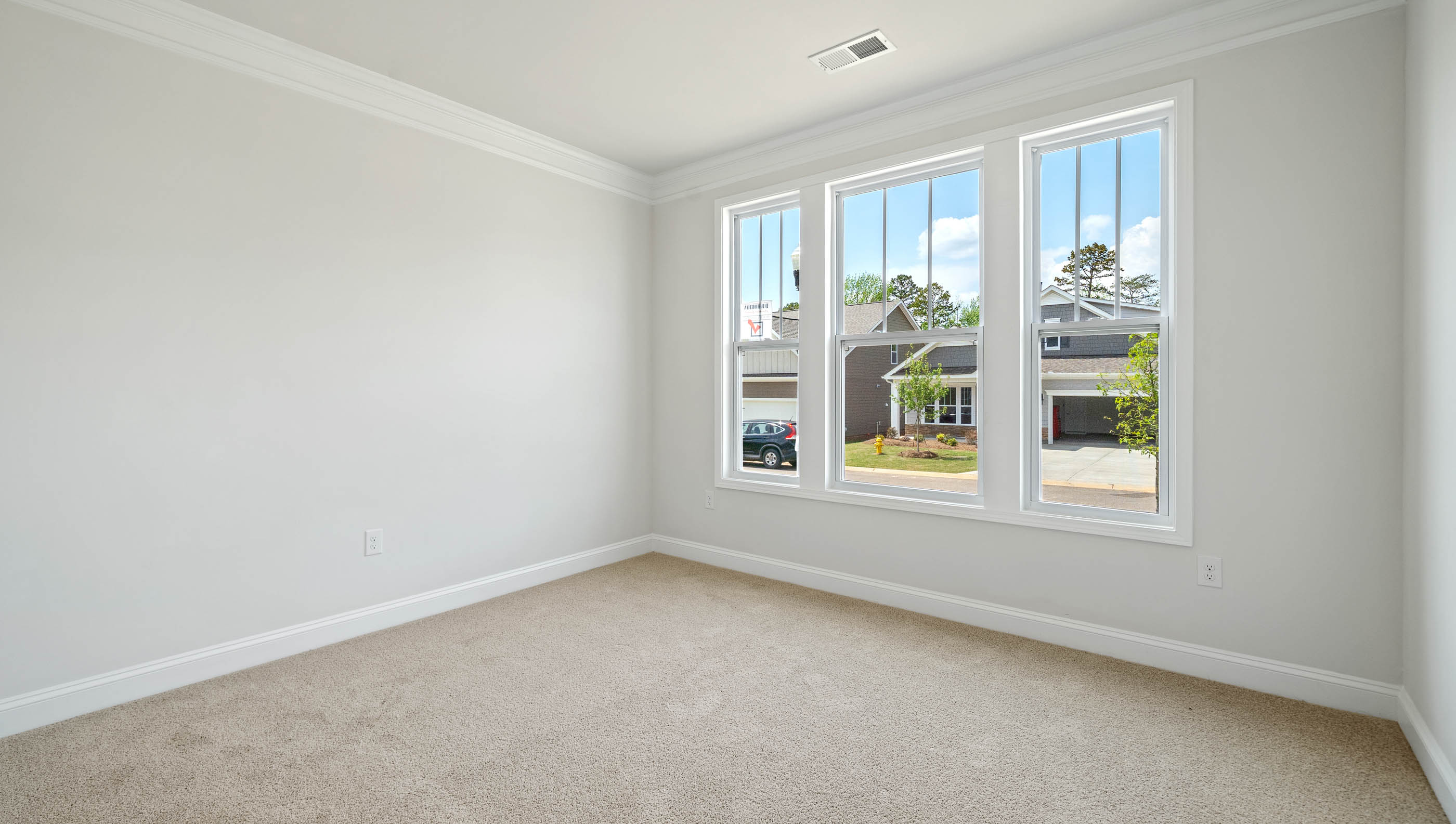 Bedroom with carpet and windows.
