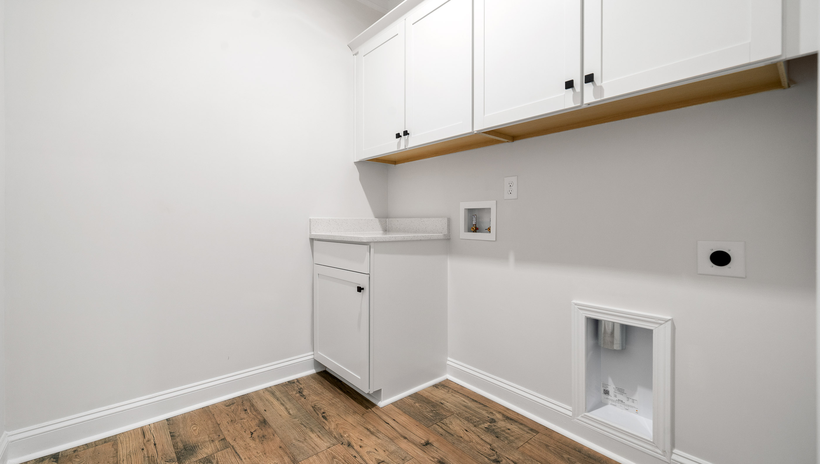 Laundry room with hanging storage racks.