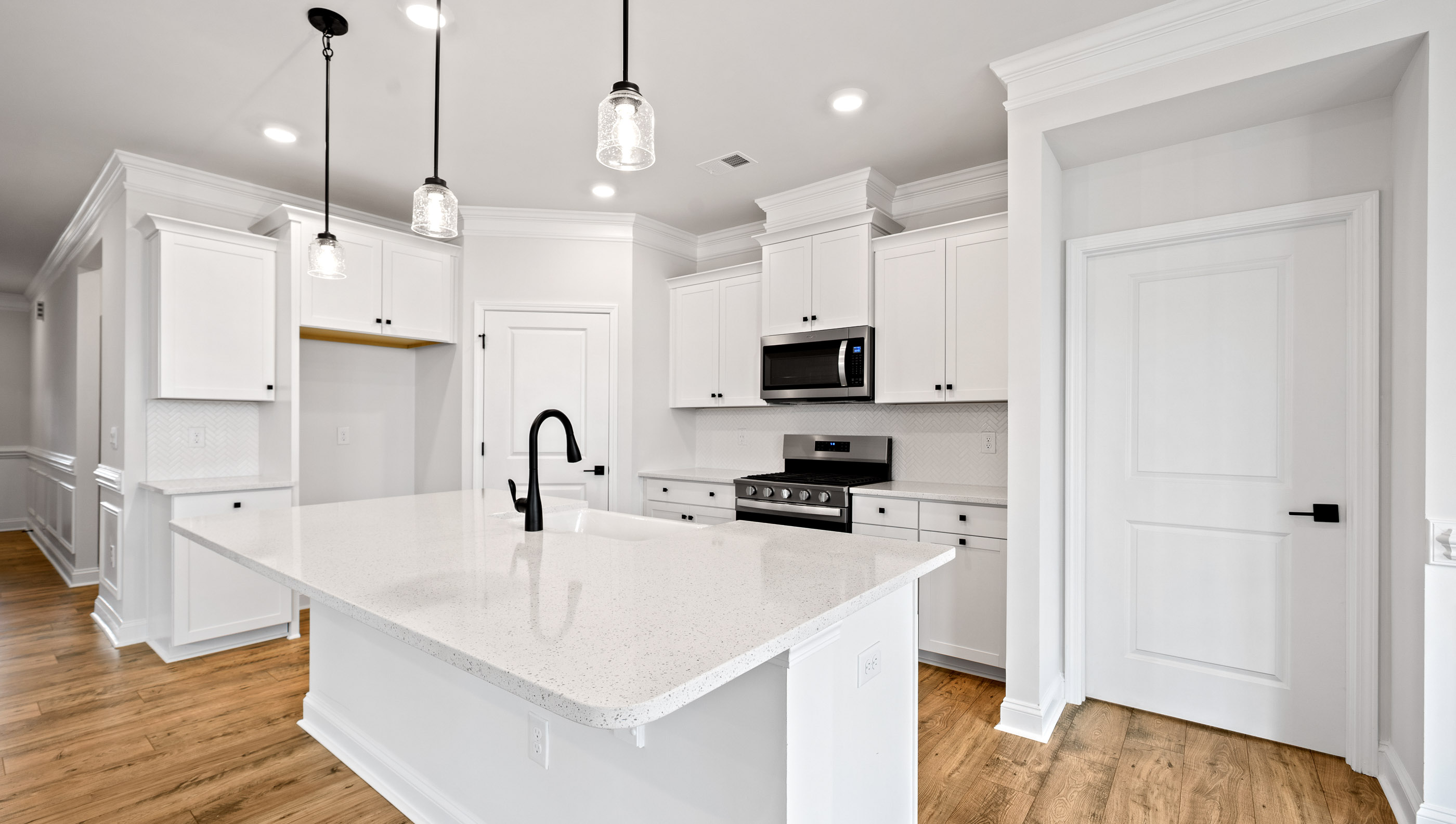 Kitchen and island with stainless steel appliances.