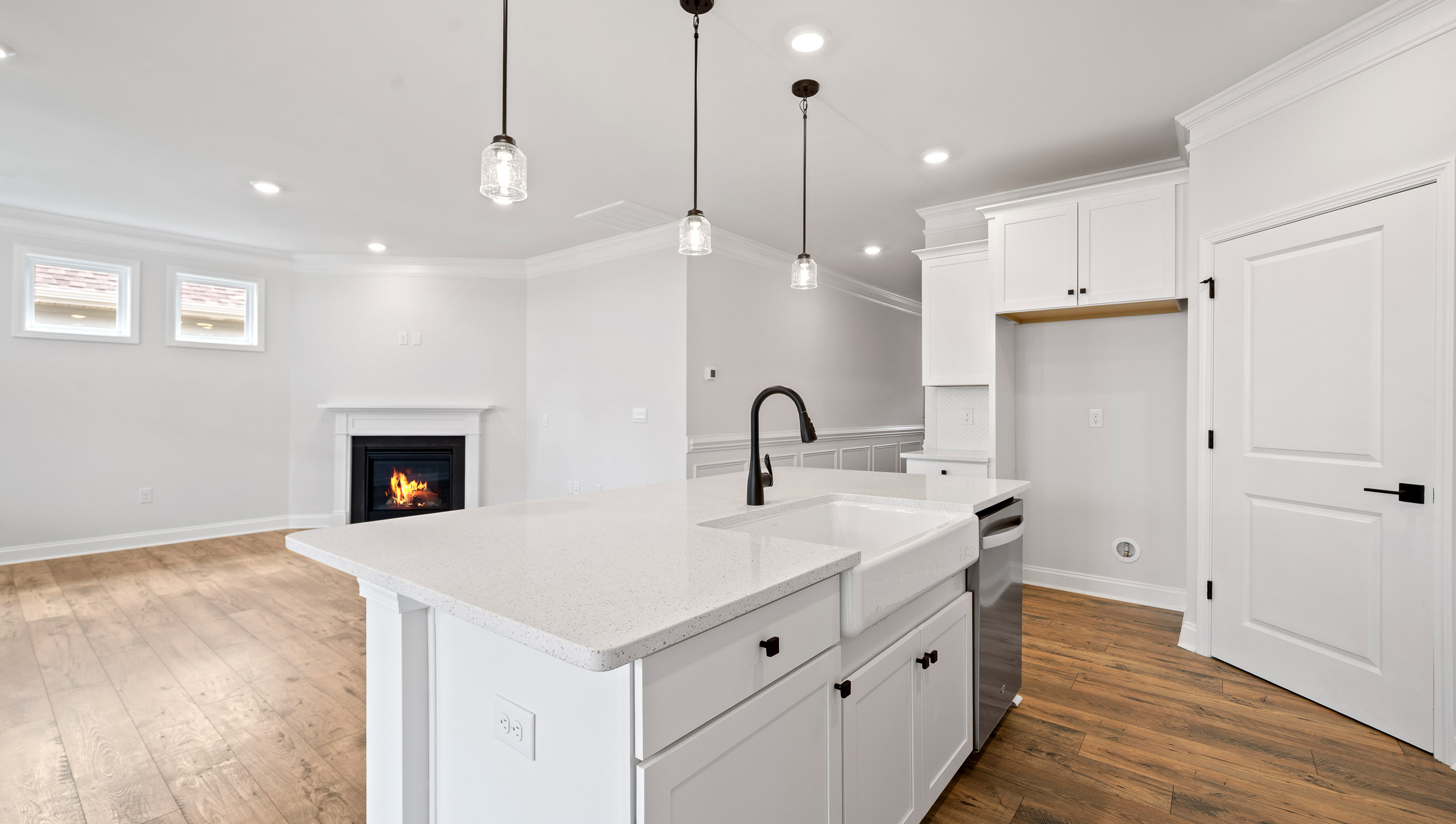 Kitchen and island with stainless steel appliances.