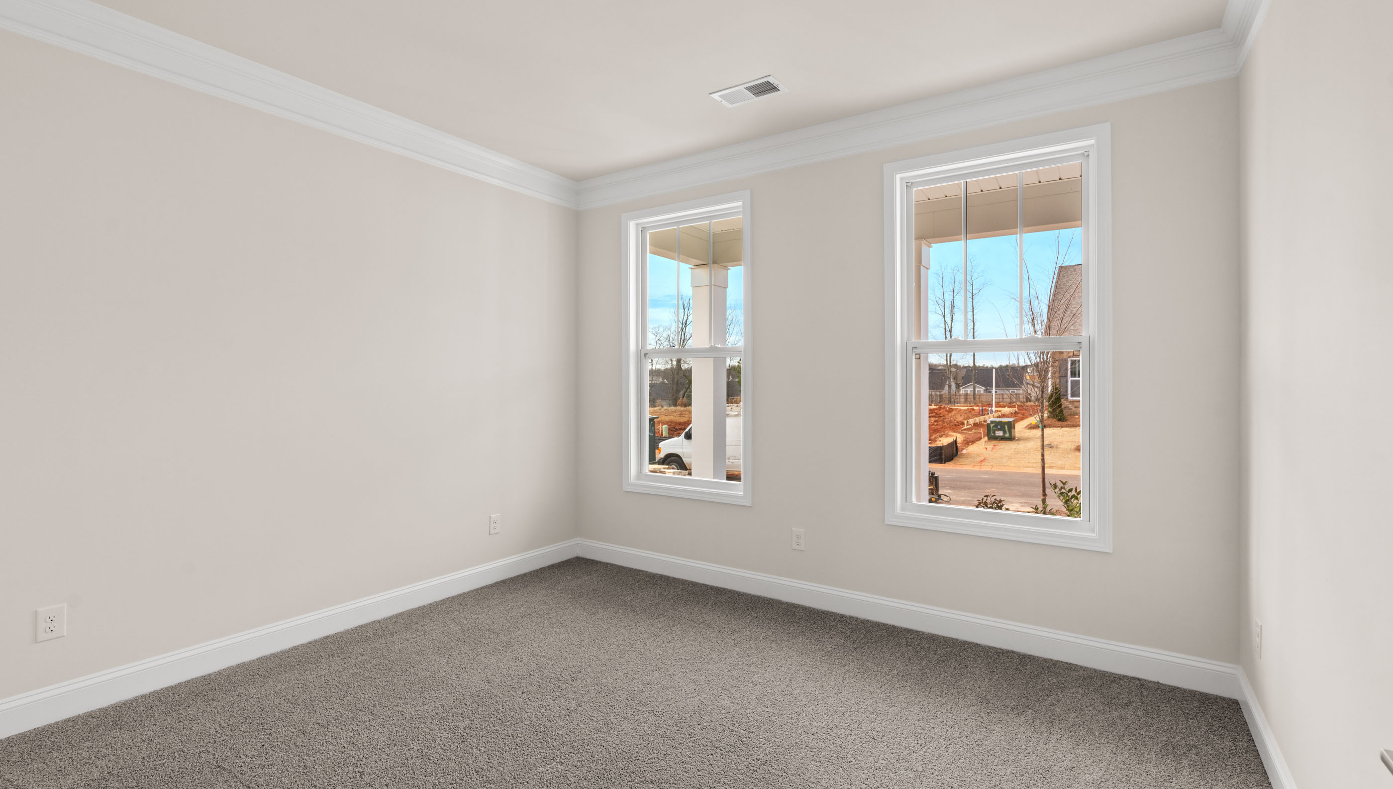 Bedroom with carpet and windows.