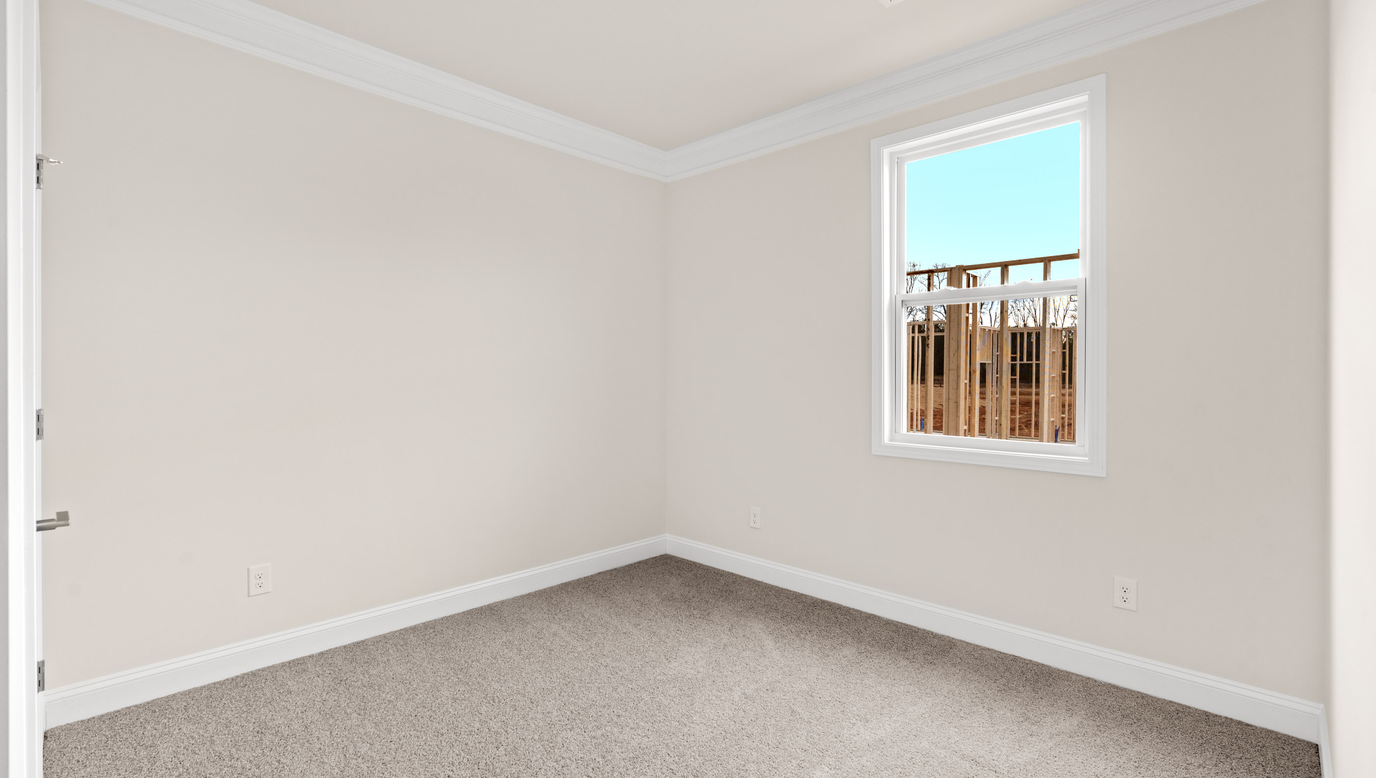 Bedroom with carpet and window.