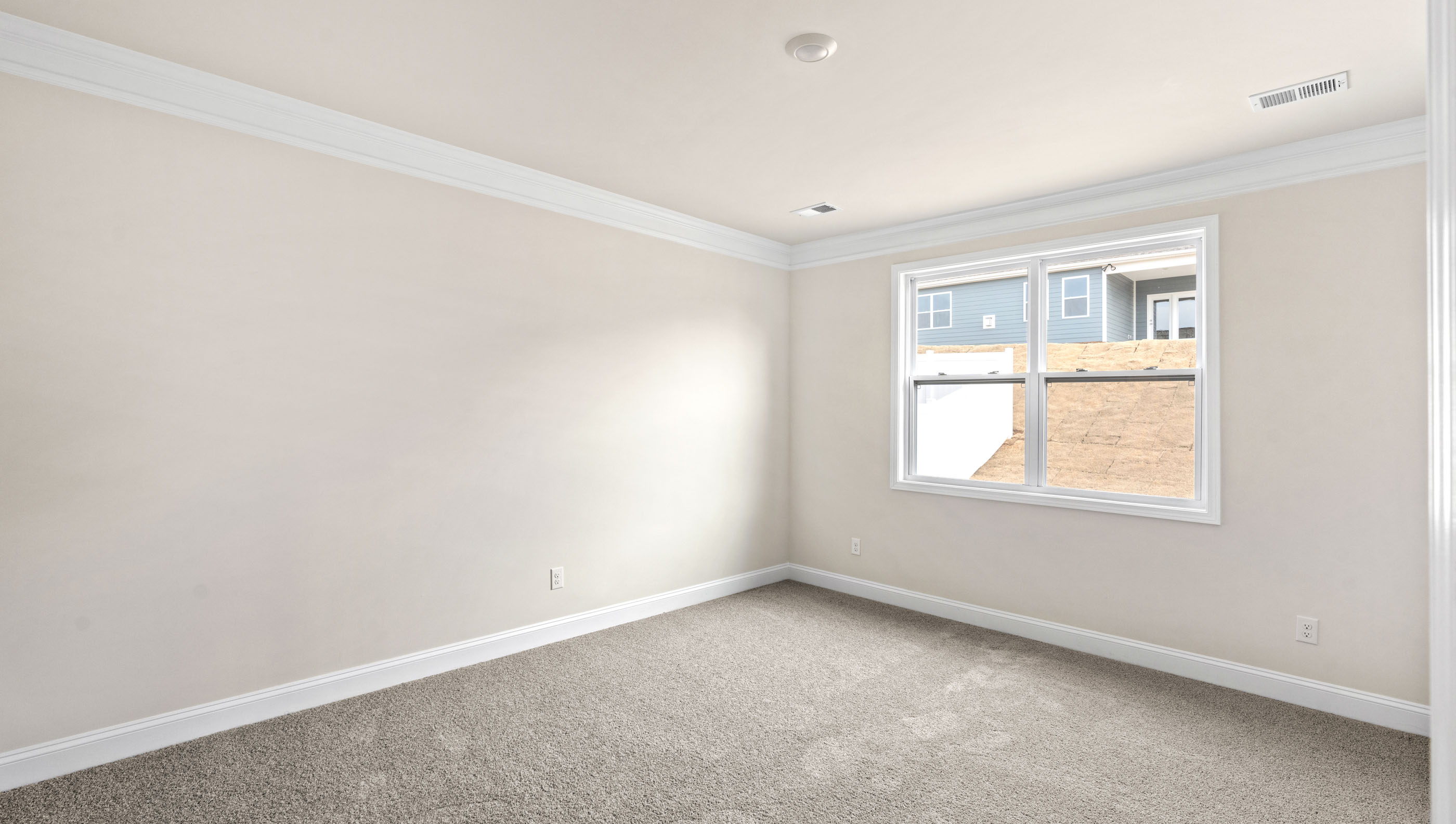 Bedroom with carpet and windows.