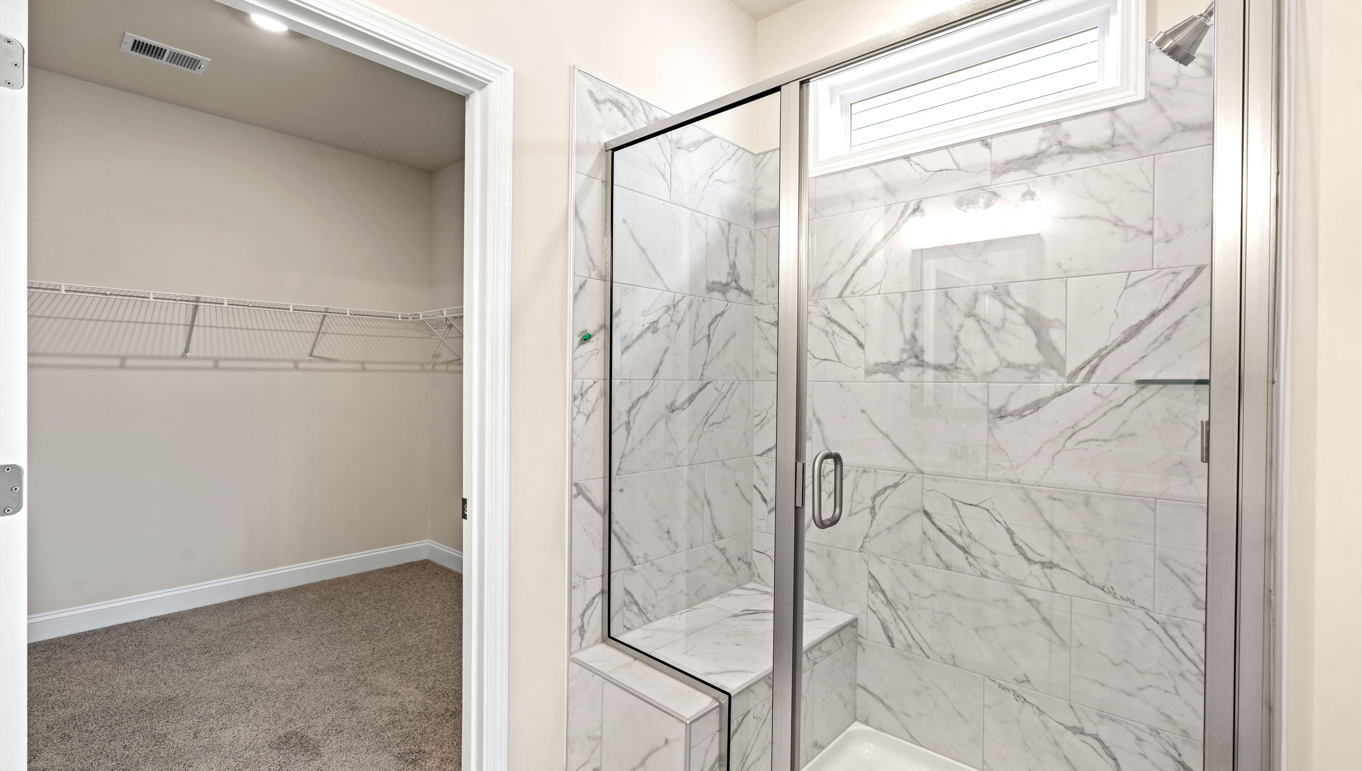 Bathroom with walk in shower and closet.