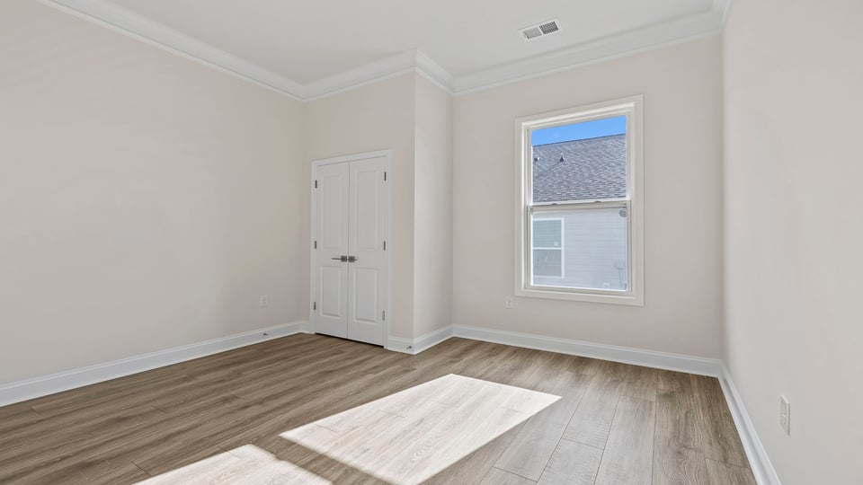 Bedroom with window and closet.