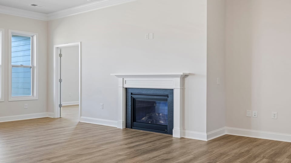 Living room with windows and fireplace.