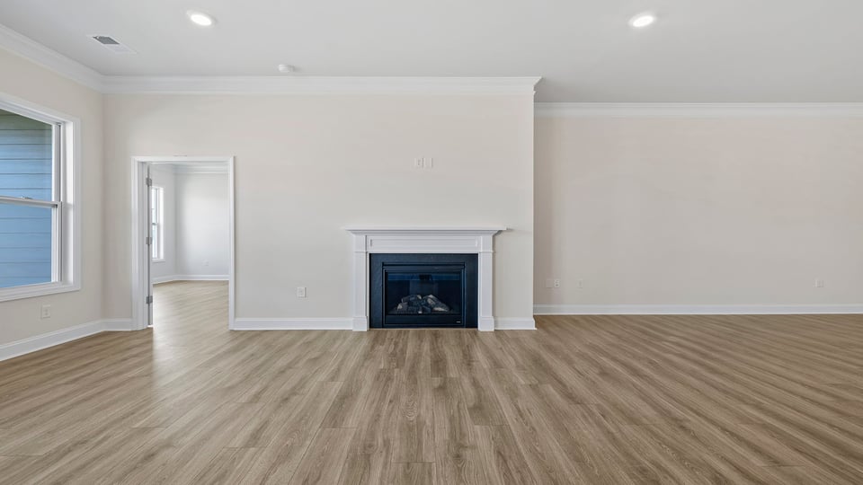 Living room with windows and fireplace.