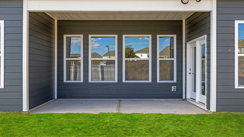 Back exterior with large backyard.