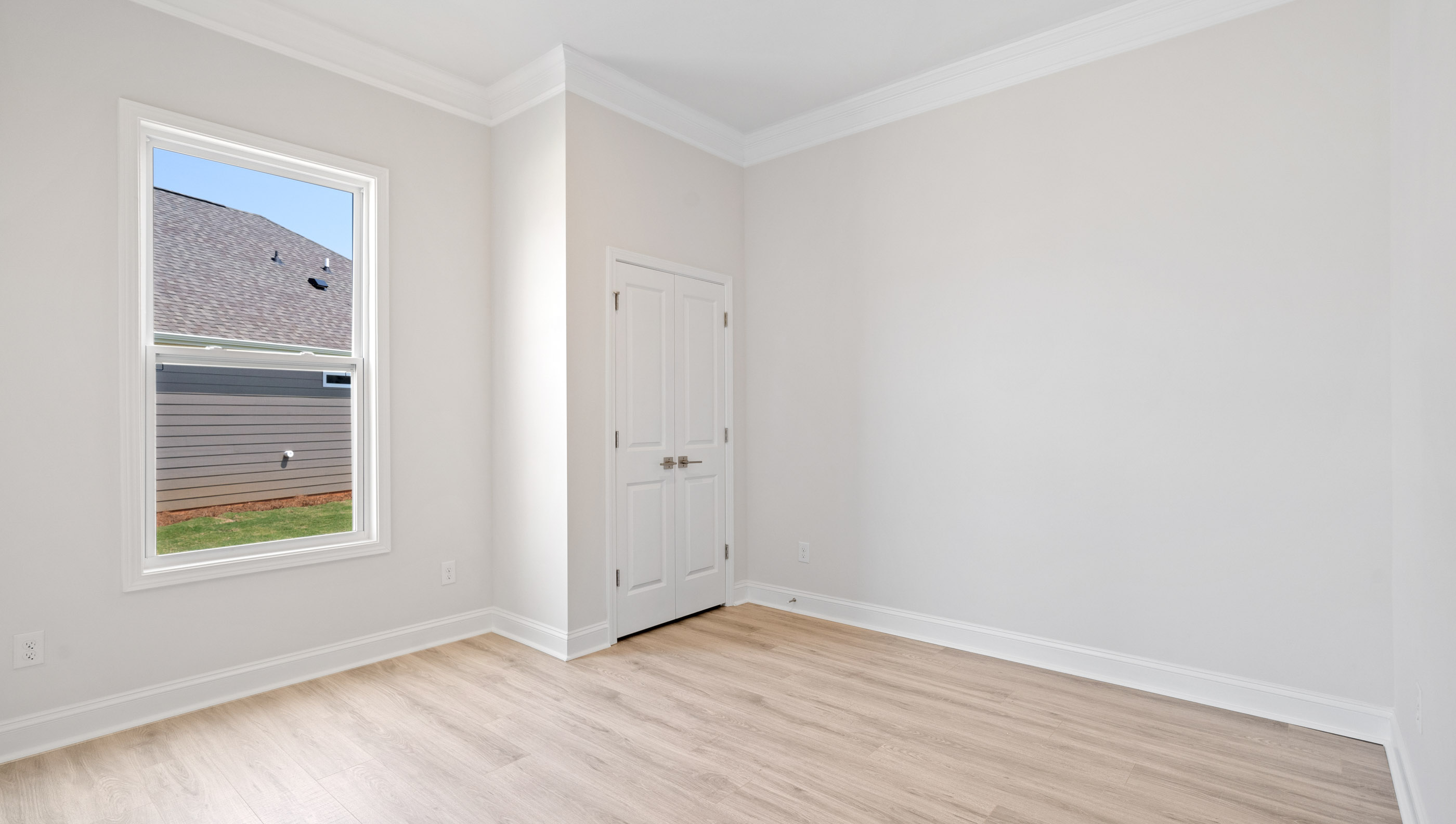 Bedroom with window and closet.