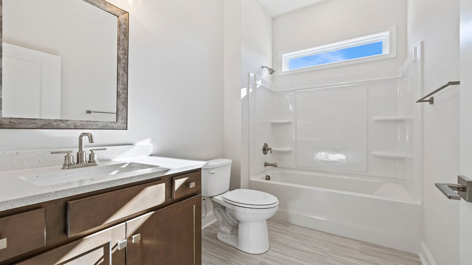 Hall bathroom with vanity and combination shower / tub.