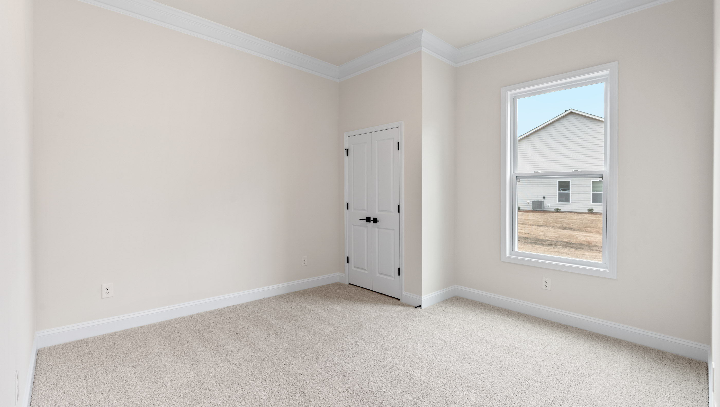 Bedroom with carpet and window.