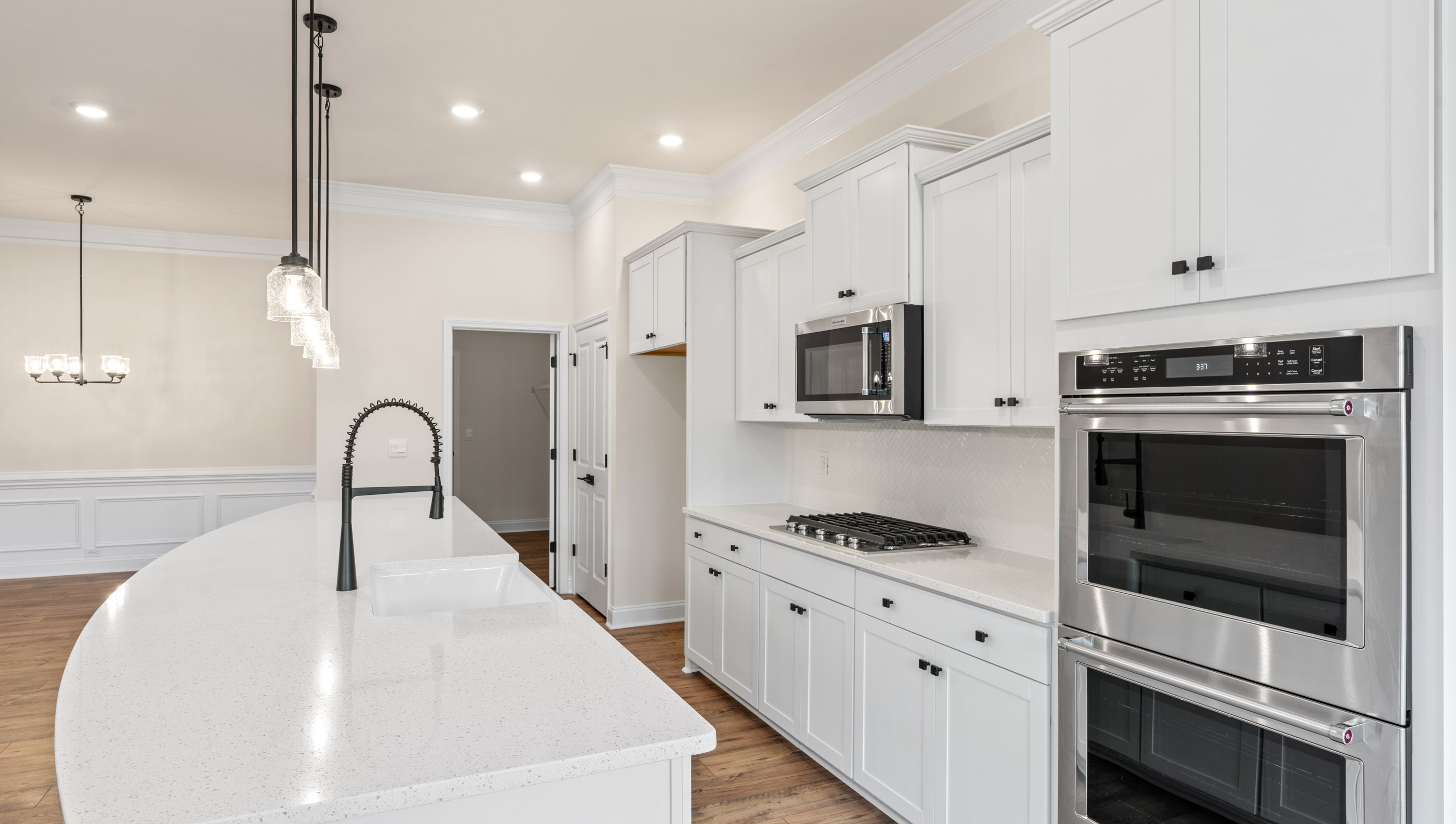 Kitchen and island with stainless steel appliances.