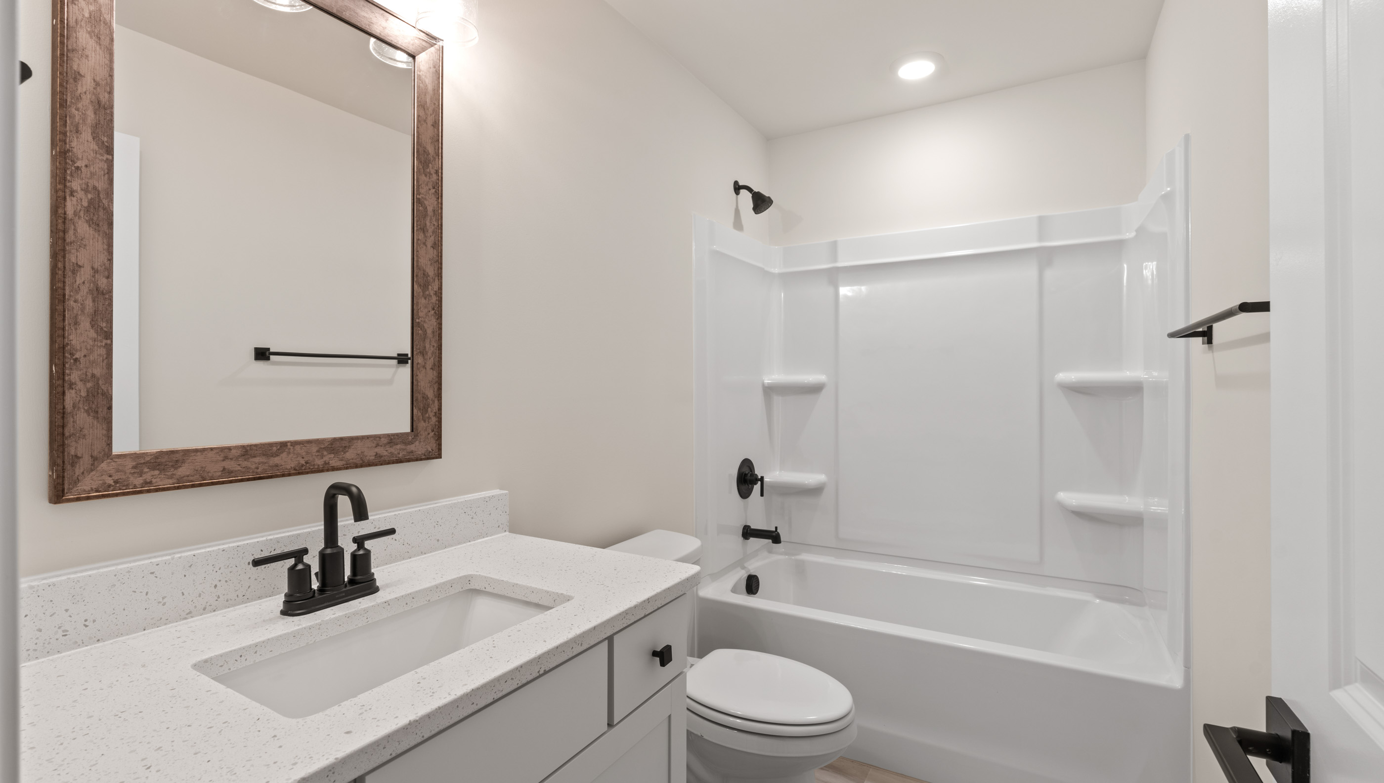 Bathroom with single vanity sink and tub.