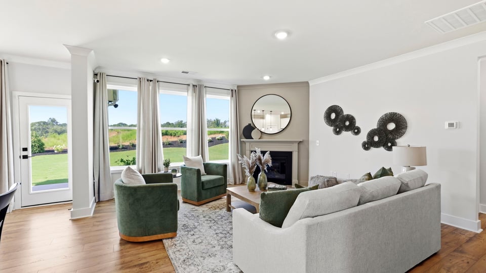 Living room with fireplace and windows.