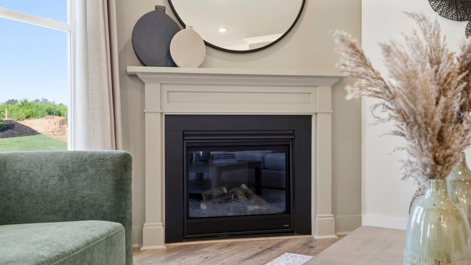 Living room with fireplace and windows.