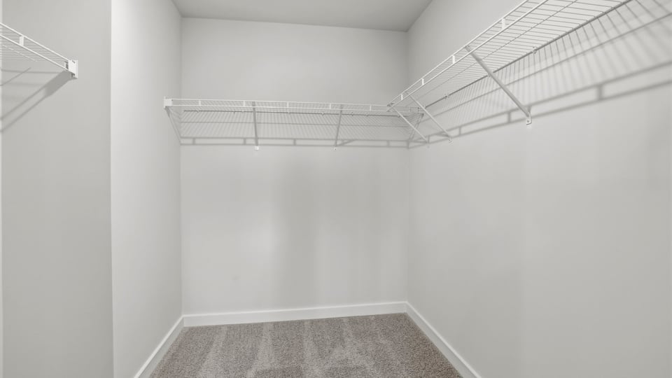 Primary closet with shelf.