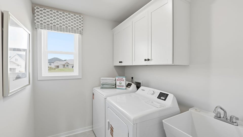 Laundry room with cabinets.