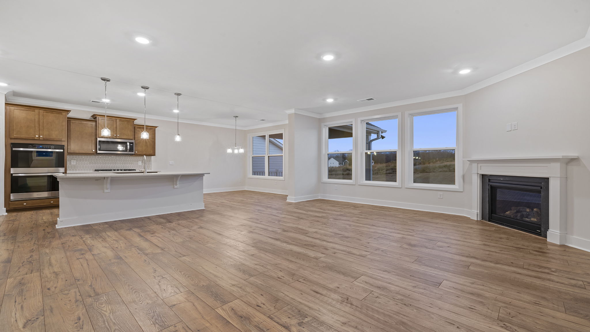 View of the living area with gas log fireplace and lots of windows.