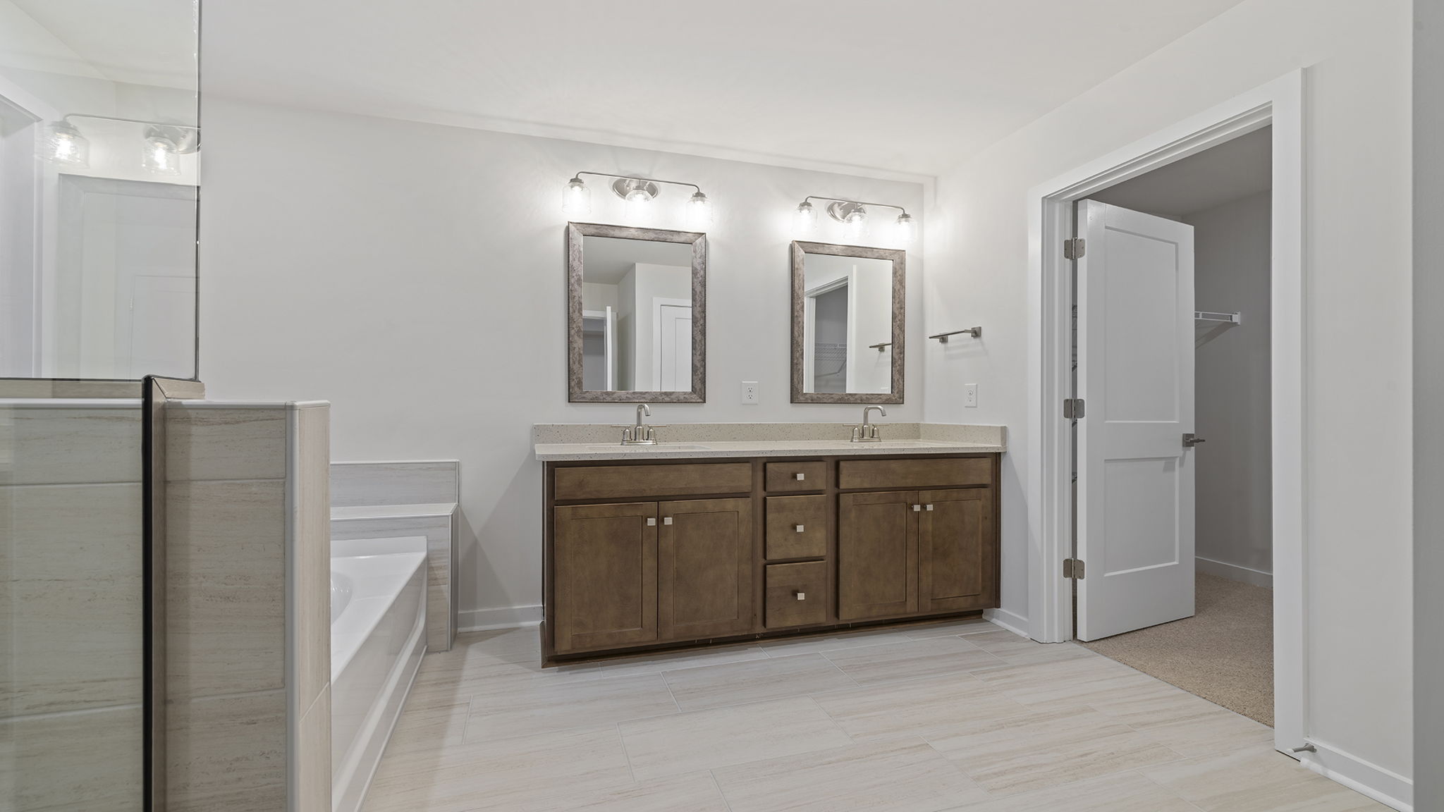 Primary bathroom with garden tub, walk-in shower and dual sink vanity.