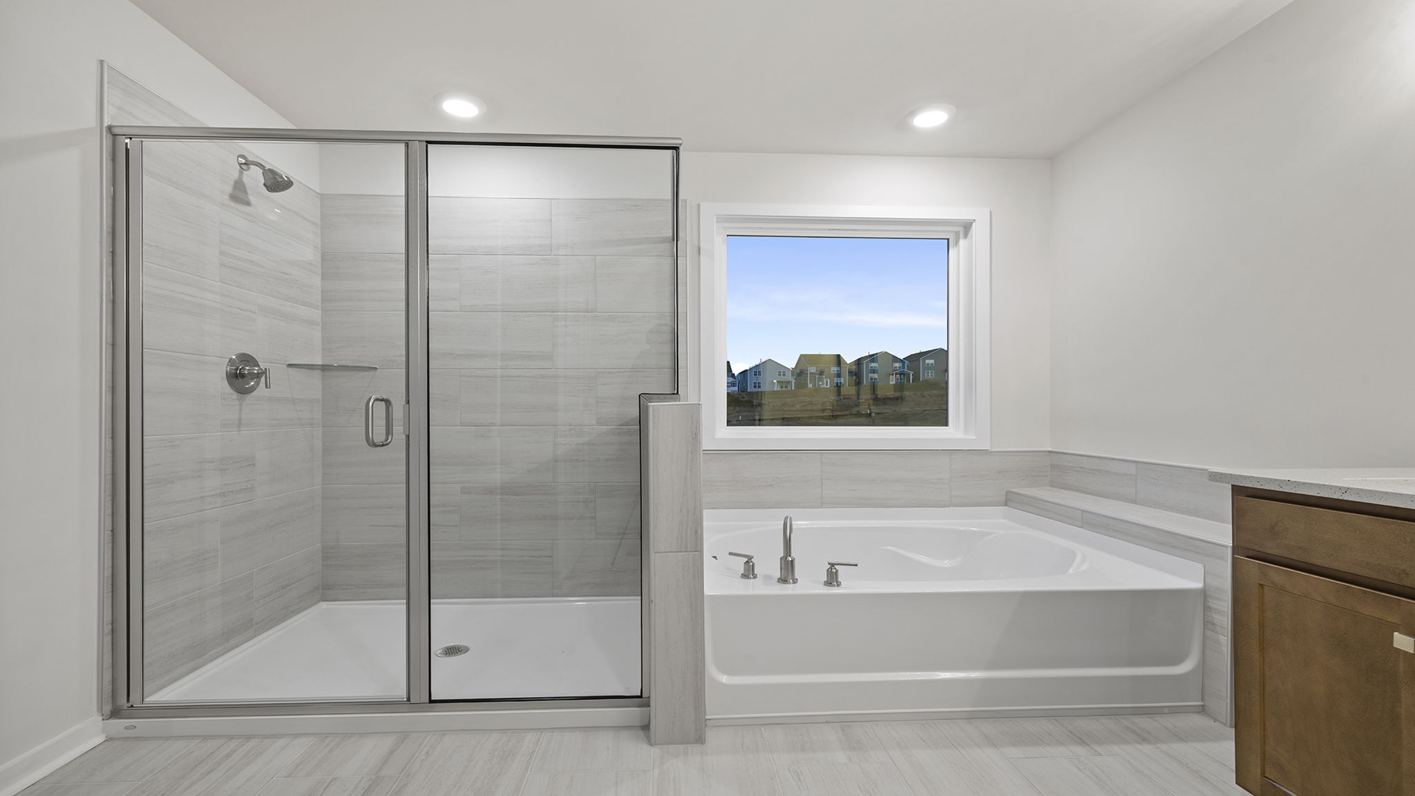 Primary bathroom with garden tub, walk-in shower and dual sink vanity.