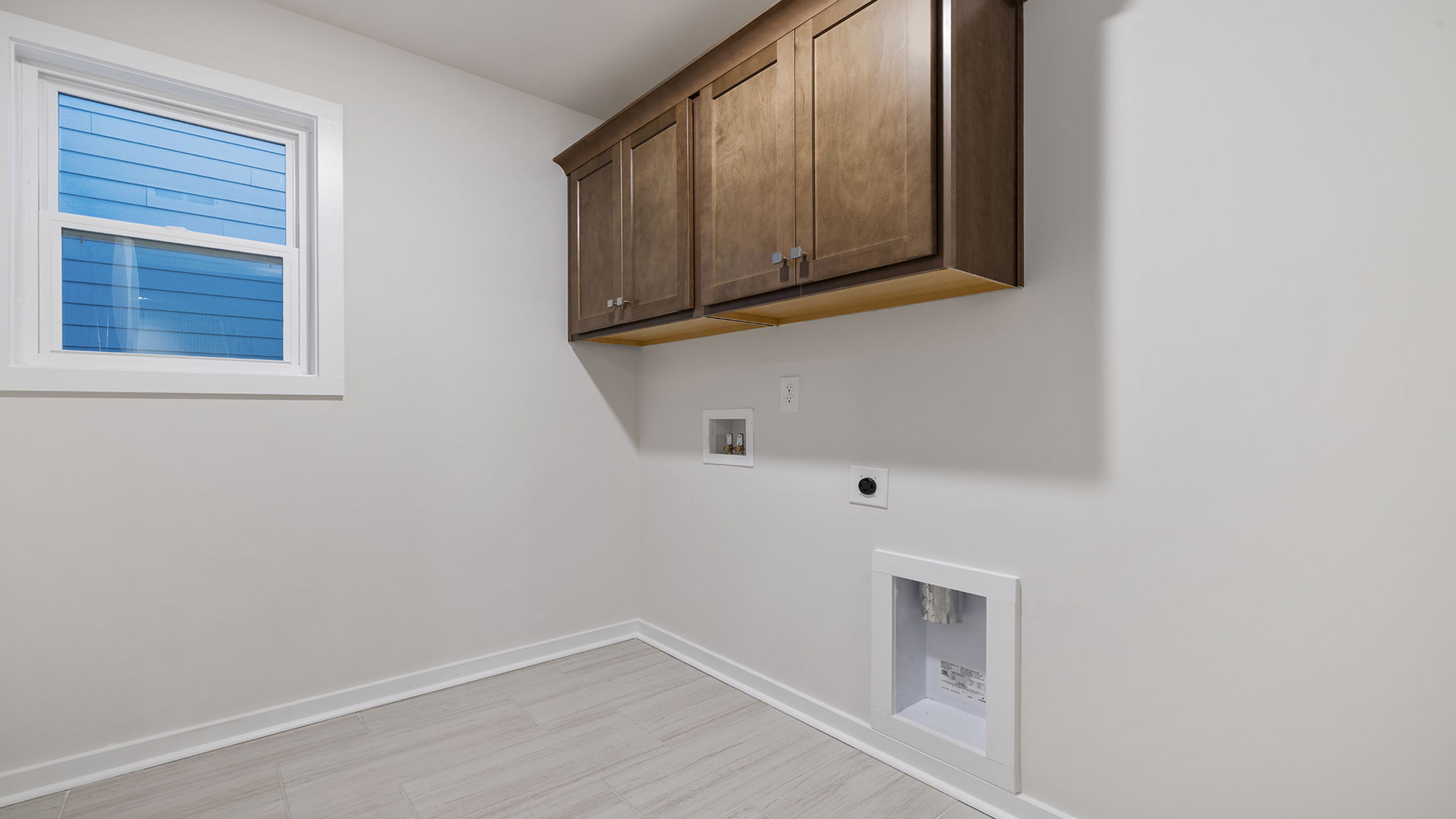 Laundry room with sink and shelving.