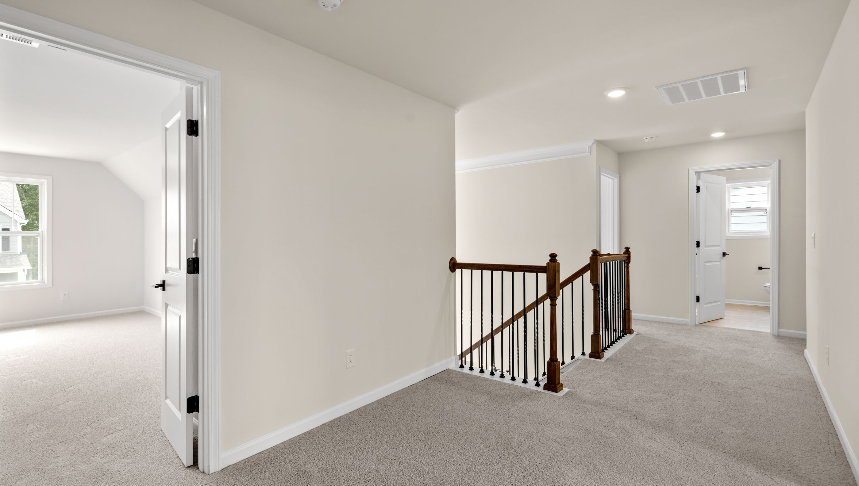 Hallway upstairs with carpet.