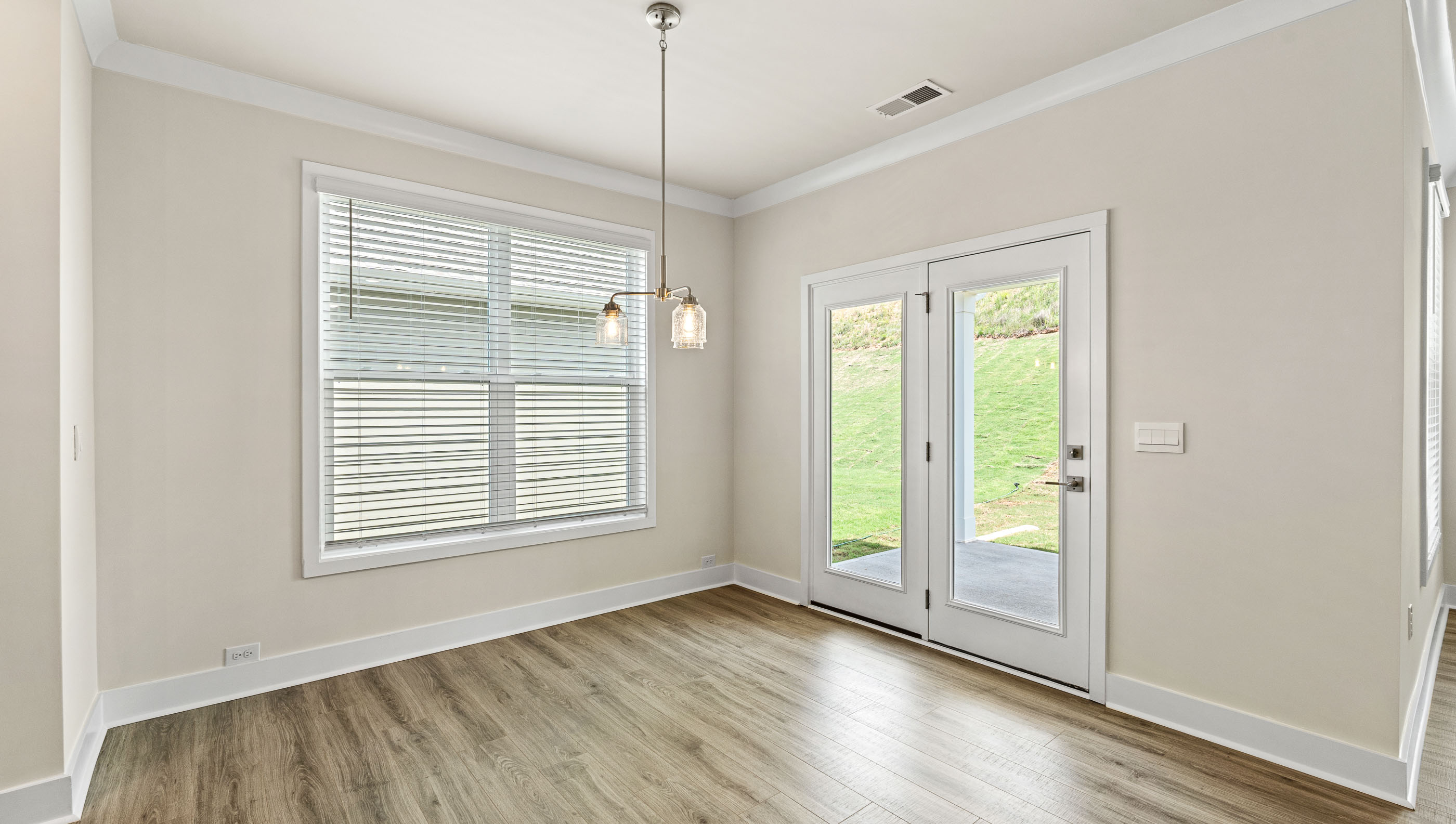 Dining area with large window and door to the back yard.