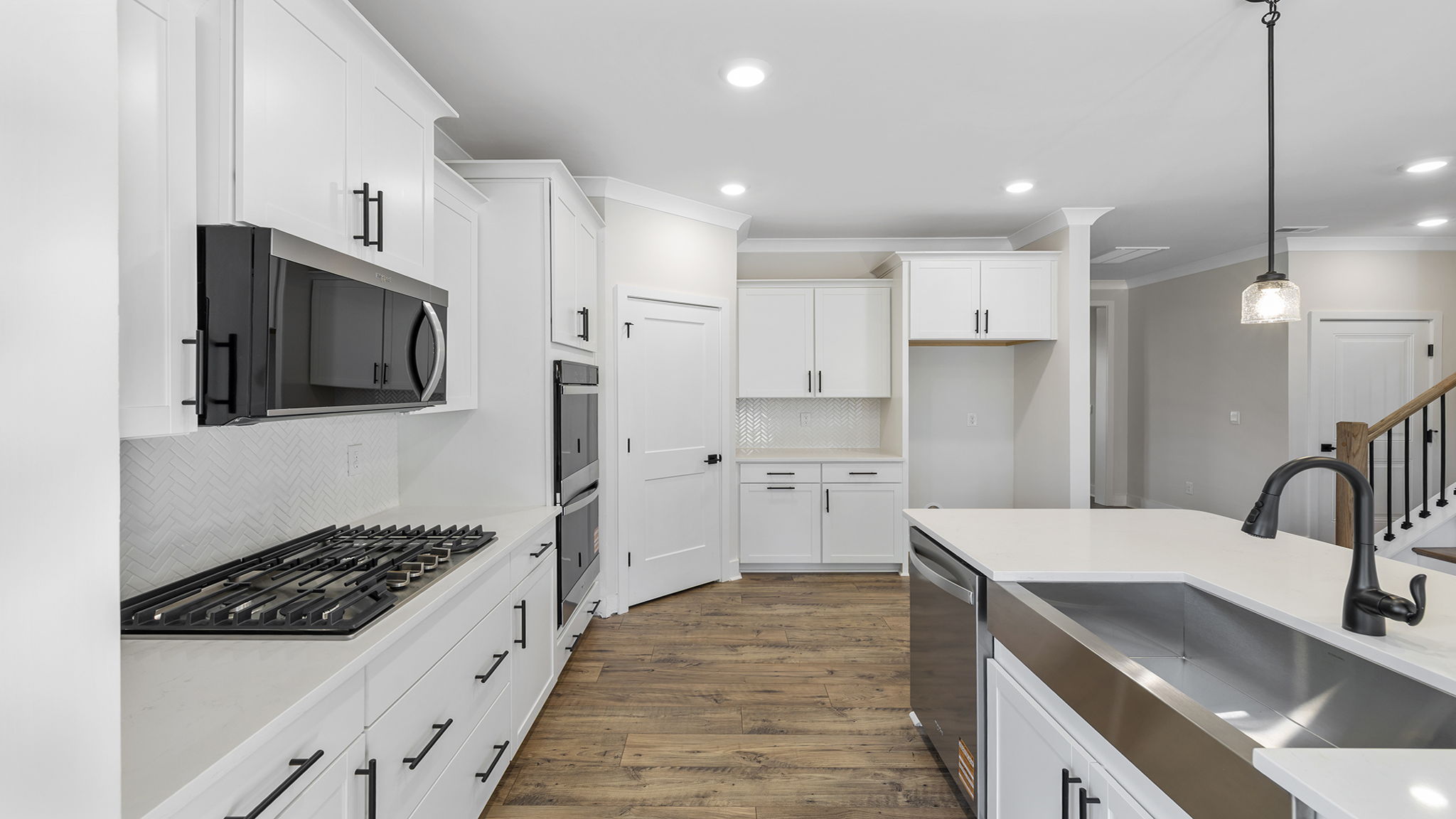 Kitchen and island have quartz countertops.
