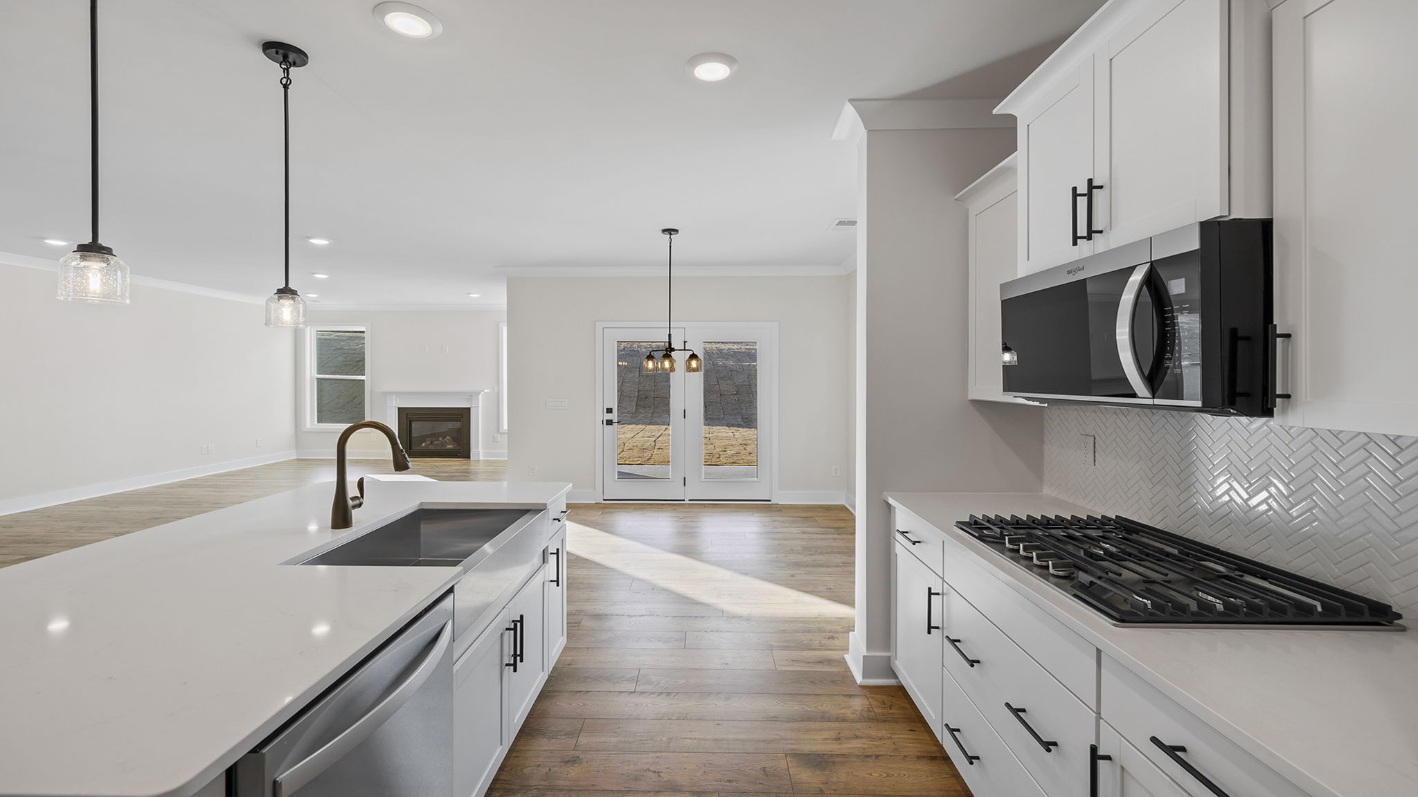 Kitchen and island have quartz countertops.