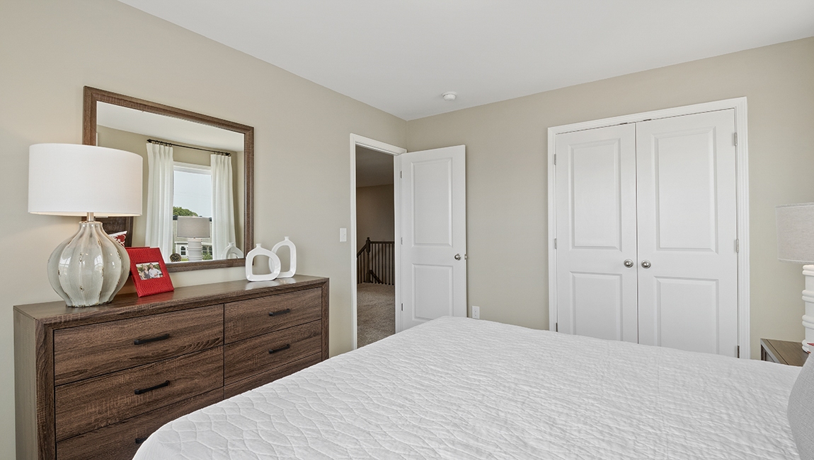 Bedroom with carpet and window.