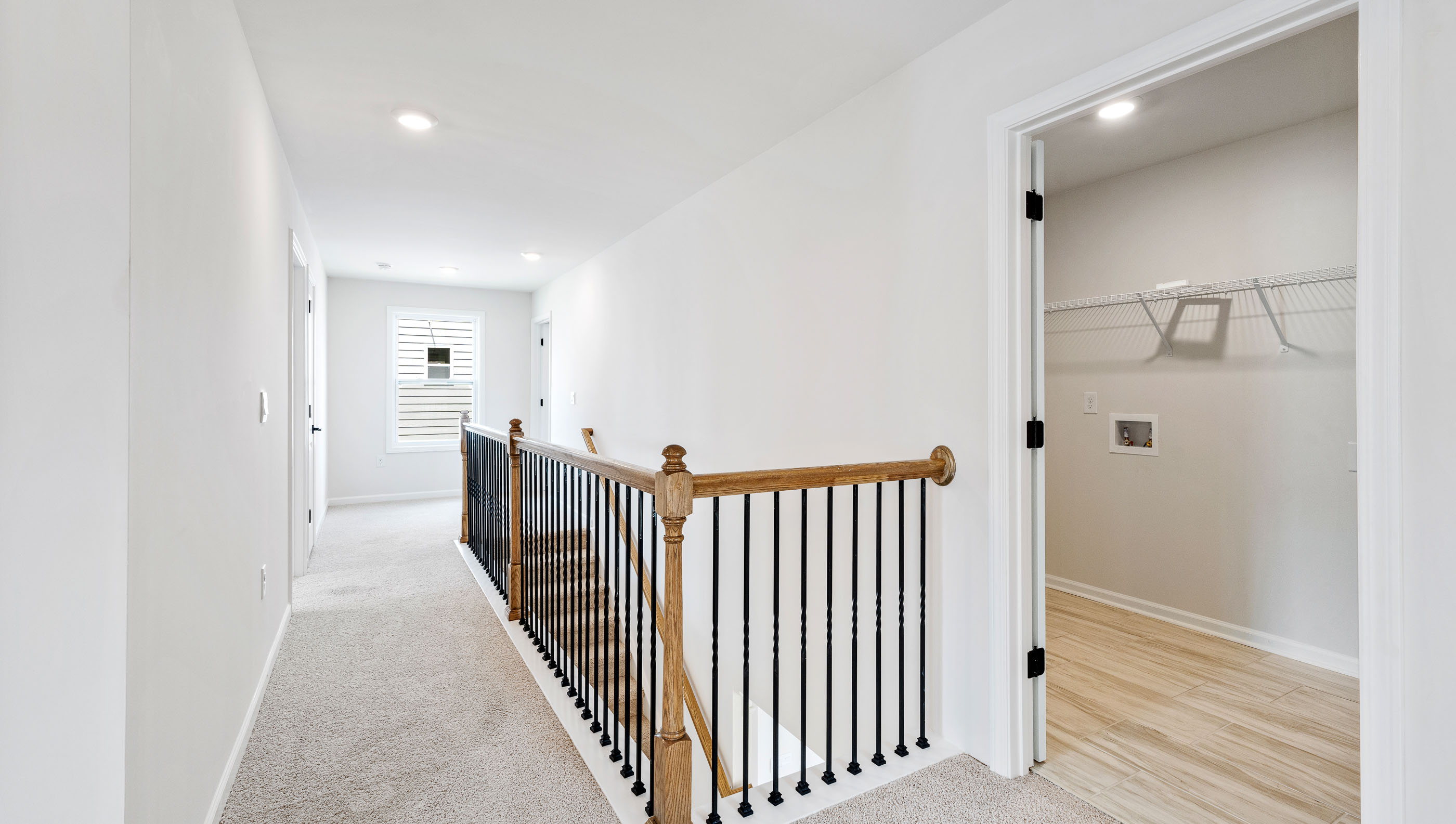 Loft area with carpet and window.