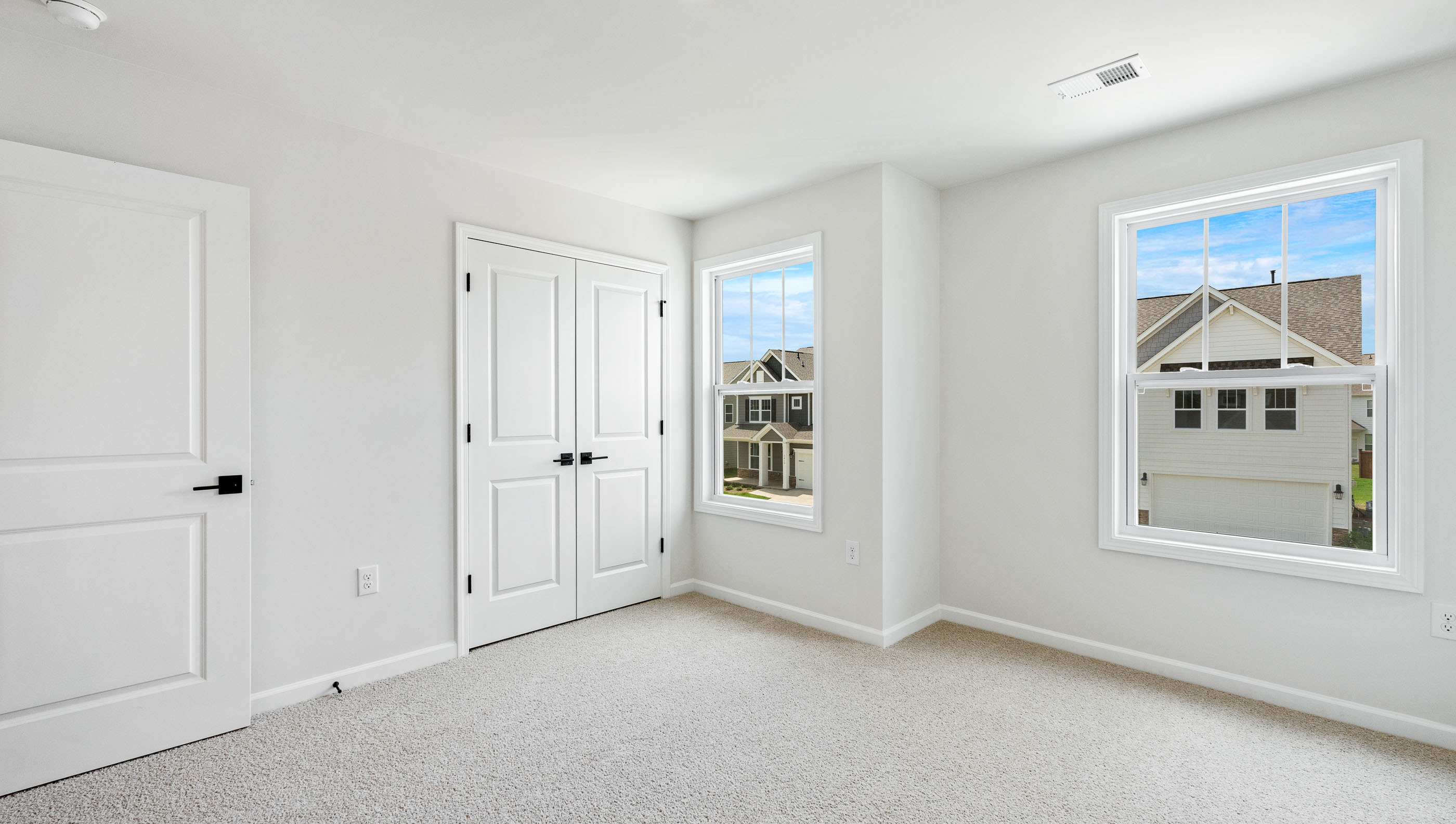 Bedroom with carpet and window.