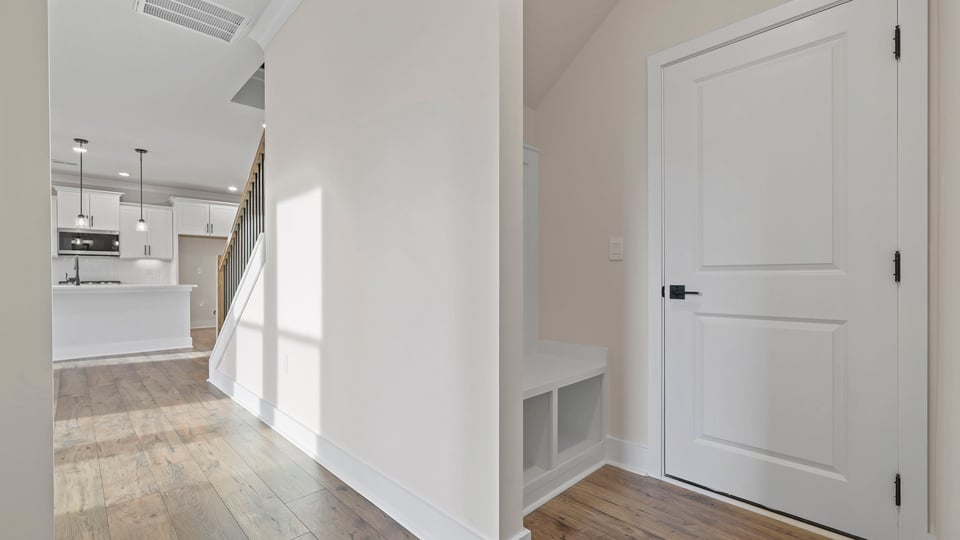 Hallway to kitchen with cabinet.